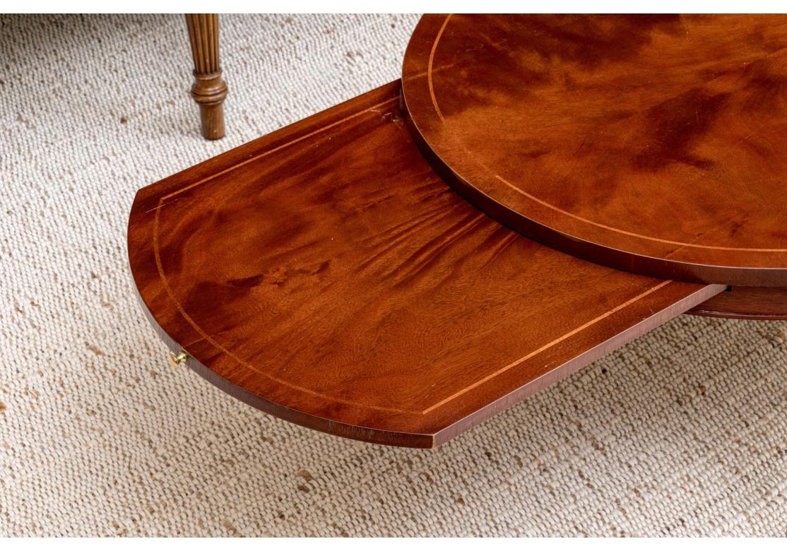 20th Century Baker Sheraton Style Mahogany Oval Cocktail Table With Pull Out Trays For Sale