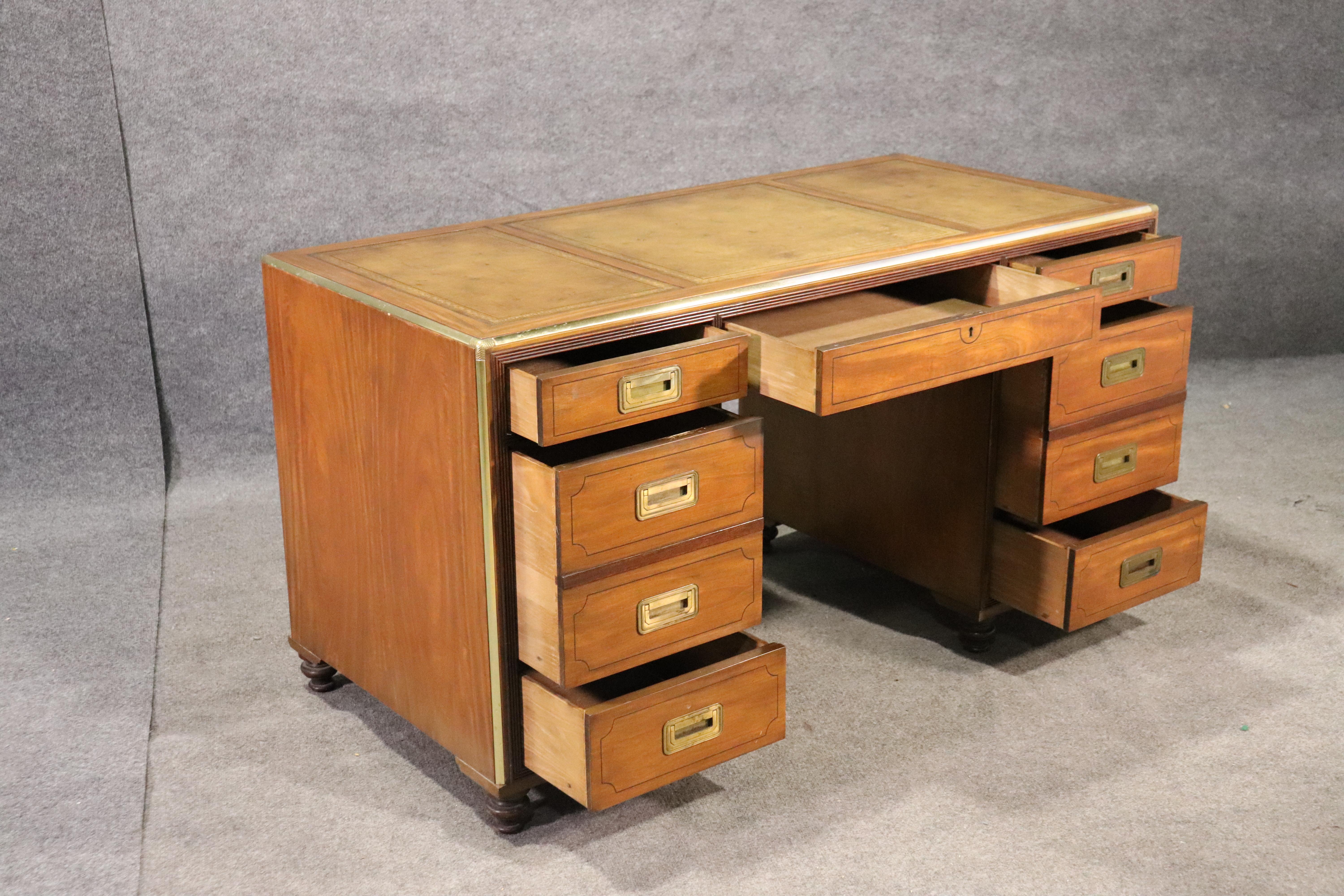 This is a classic Baker campaign desk with a bookshelf back and a gorgeous leather top. The desk is in good vintage condition and hard to find these days. The desk measures 56 wide x 27 deep x 31 tall. This is a classic style of desk that will never