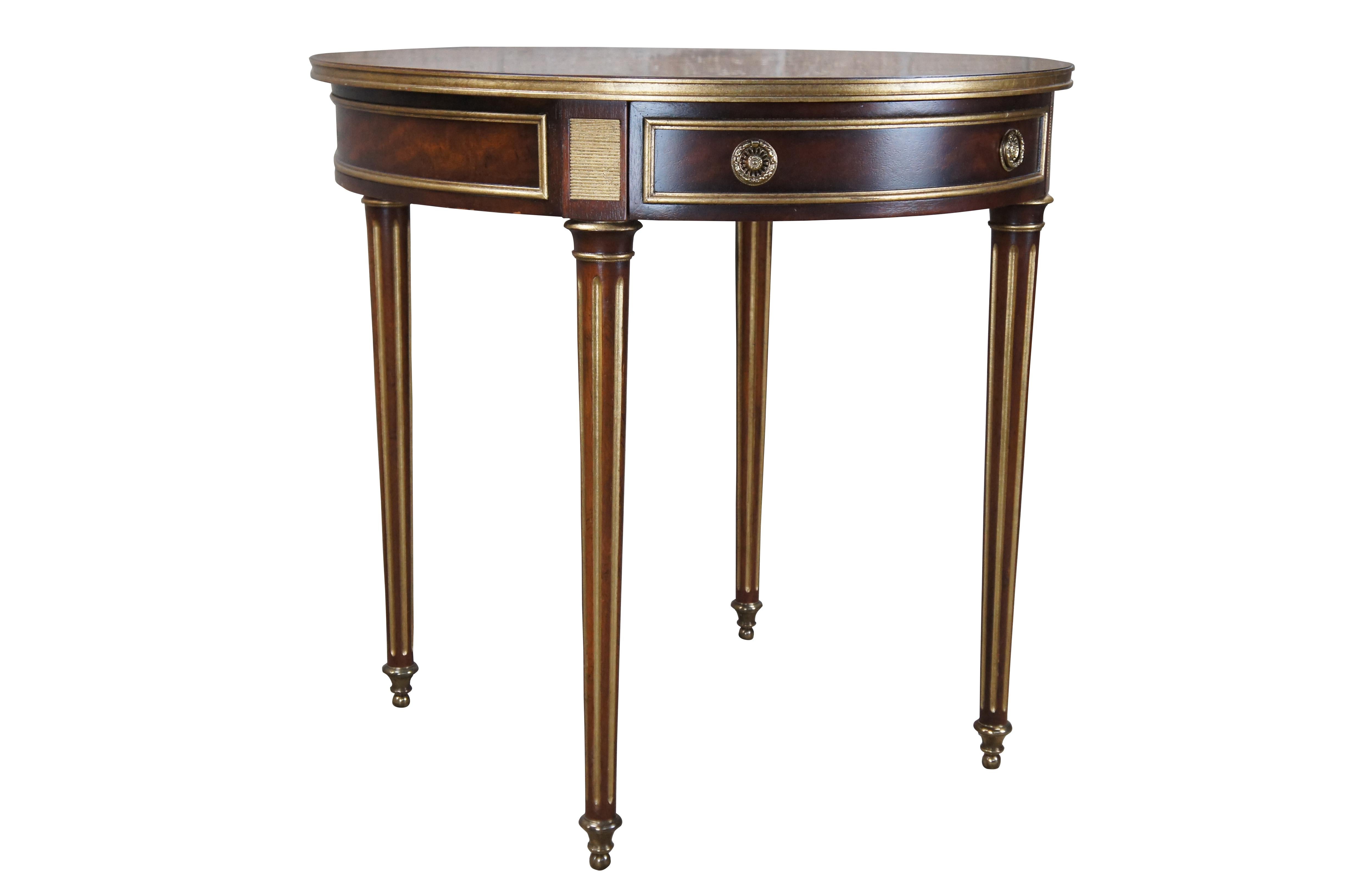Vintage Baker Furniture English Sir Humphry Wakefield Collection French Louis XVI bouillotte style side accent table.  Made of mahogany and satinwood featuring round form with sunburst bookmatch top, one drawer with brass hardware, gold gilt