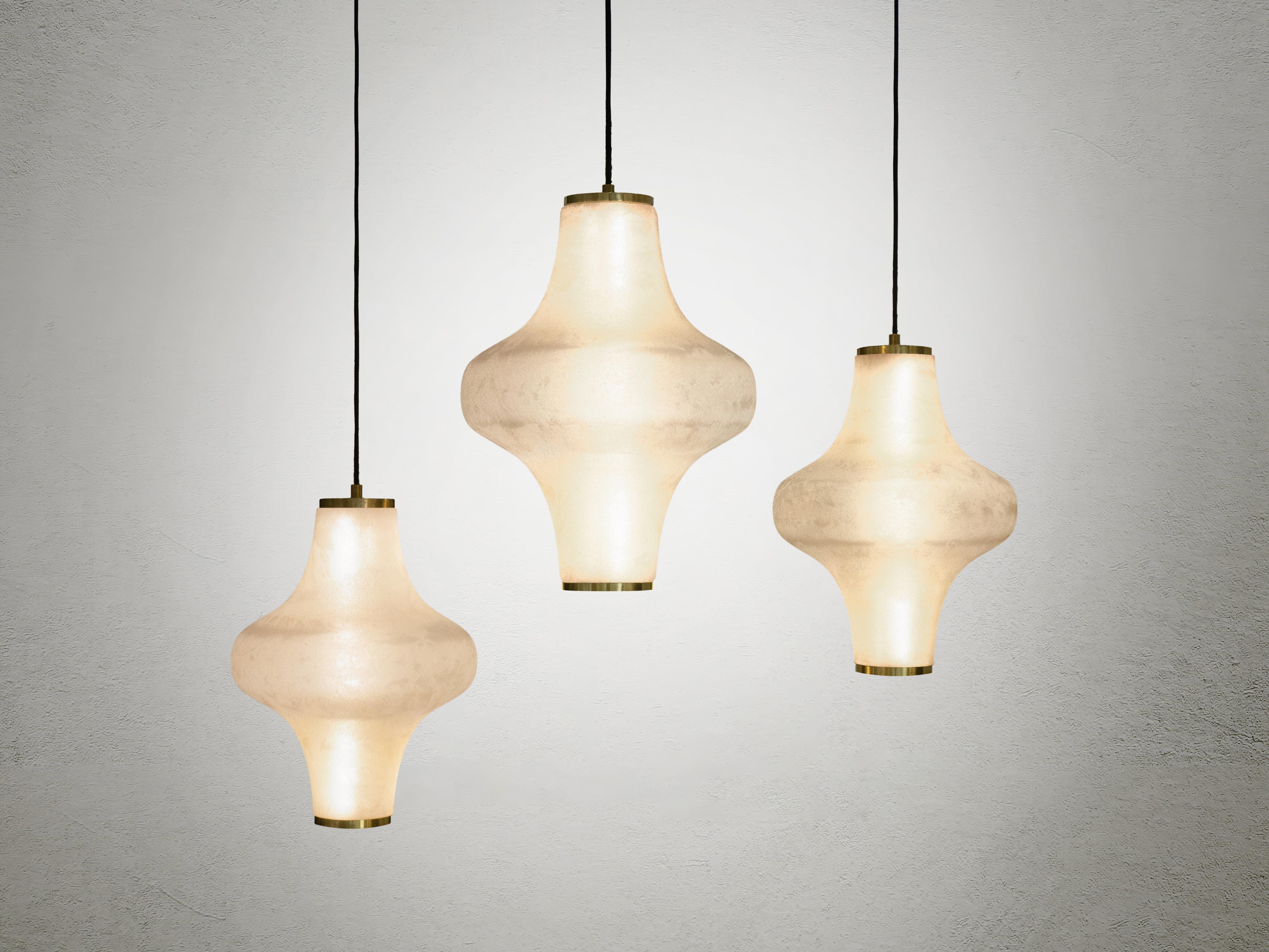 The Baker Street Muse pendant lamp features expertly acid-etched Murano glass hand-blown in wooden molds creating a delicate satin finish. This technique gives the light a soft curvature and distinctive ambiance, offering a unique visual and sensory