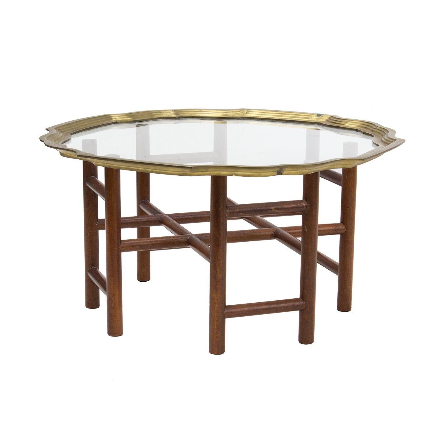 USA, 1970s
Baker style petite tray top table. Solid mahogany lattice base, glass top rimmed in brass. Unusual smaller size for a cocktail table- would be great with two chairs in a smaller seating area.
Condition notes: Brass edges of tray top