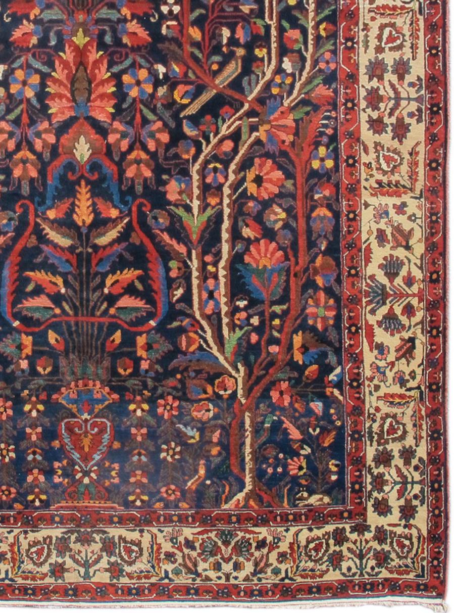 This Bakhtiari carpet draws a large niche within red spandrels. Directional Persian carpets of this large a size are quite rare but the grand scale of this piece does provide for magical potentials. Flowering trees blossom with a variety of plumage