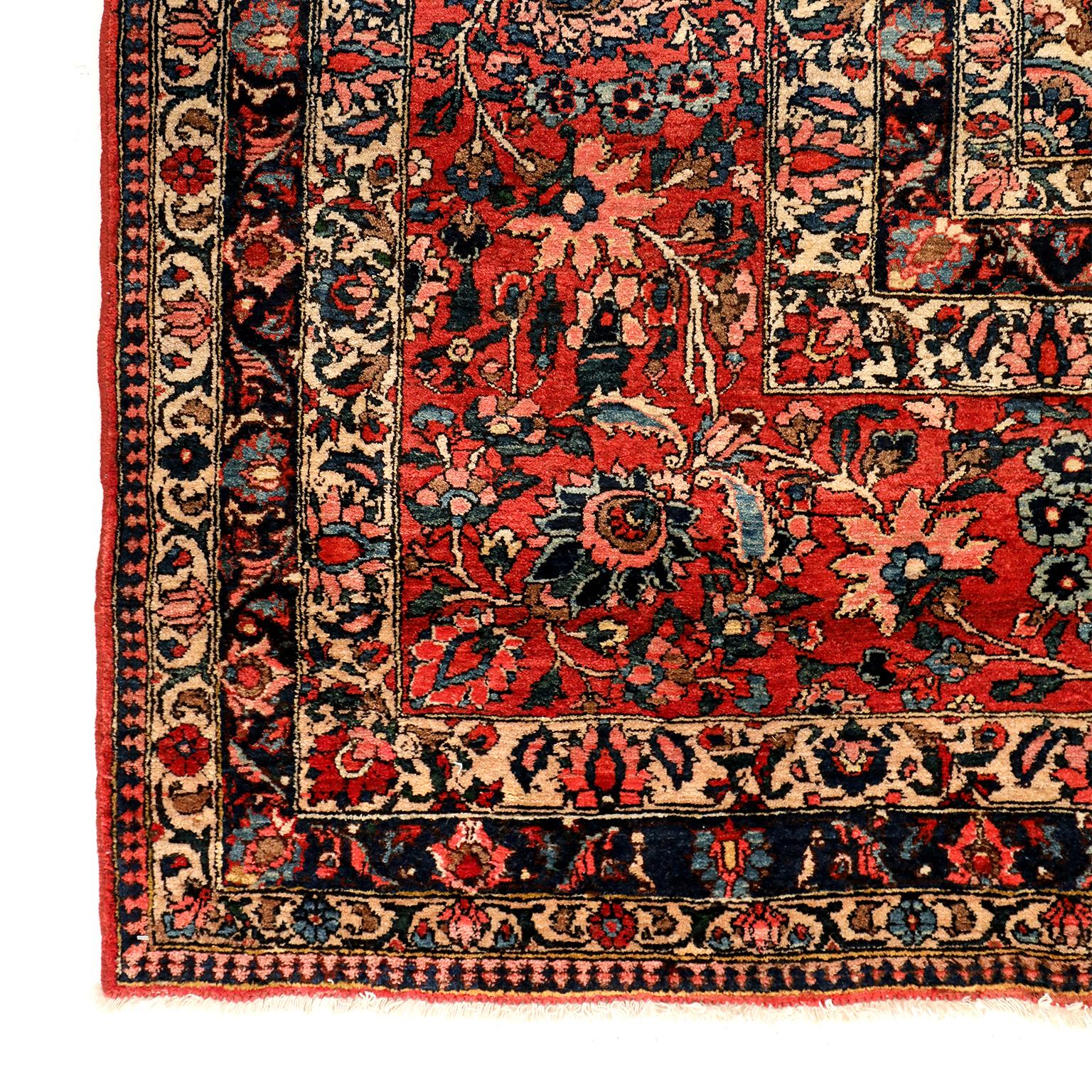 This Bakhtiari Persian carpet circa 1910 in pure wool and vegetable dyes features an intricate central medallion and multiple borders. Detailed floral motifs lend movement and depth to the design, which is further balanced by the carpet's organic