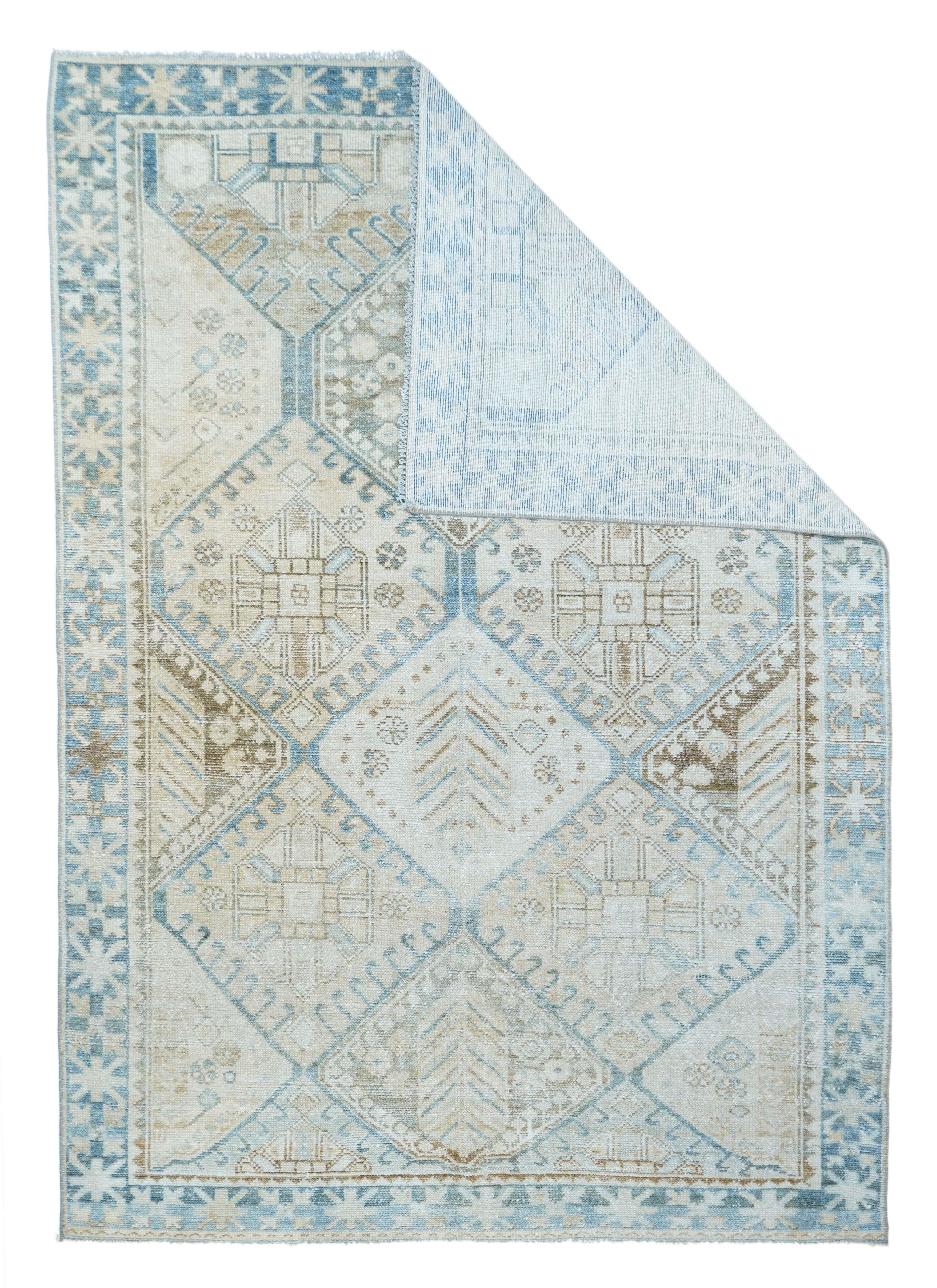 In a much reduced palette instead of the usual saturated one, this Chahar Mahal district village scatter presents a large, allover hooked hexagon design in cream, rust and straw, with feathers or abstract four palmette crosses within. Abrashed light