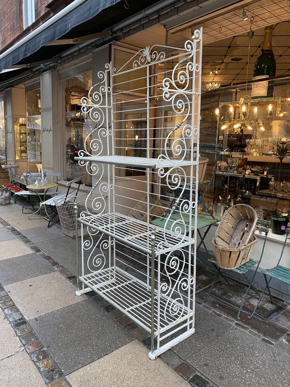 Charming eye-catching vintage French baking rack dating back to circa 1900. The shelves are made of solid wrought iron, cast iron and chrome, and have many fine curved details. Painted white. Gorgeous patina. Note the fine emblem at the top,