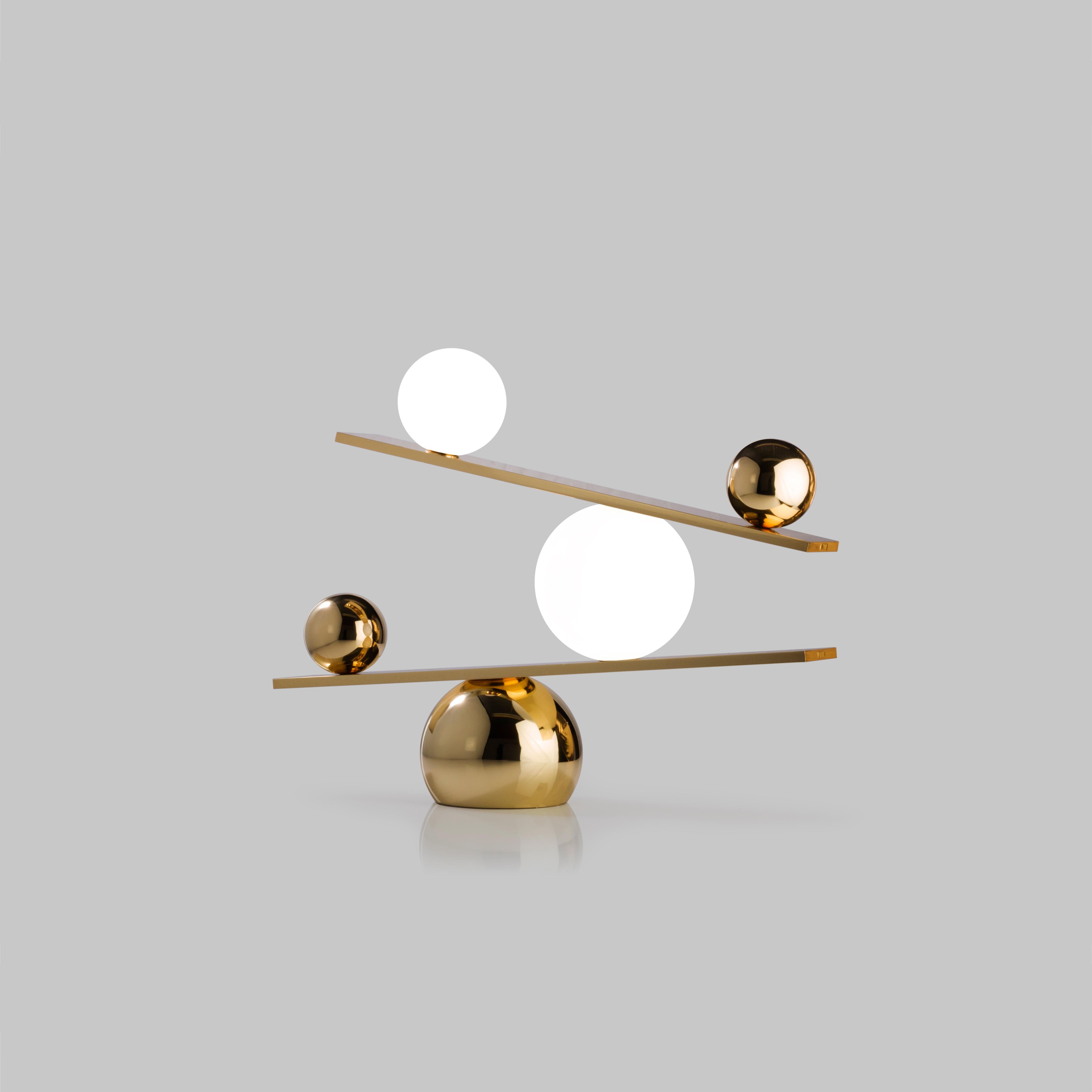Balance brass table lamp by Victor Castanera 
Balance is a playful and curiosity evoking tribute to the concepts of gravity and time.
Dimensions: 40 (H) x 53.5 (L) x 13 cm
Materials: Plated brass with steel base (also available in Glossy paint