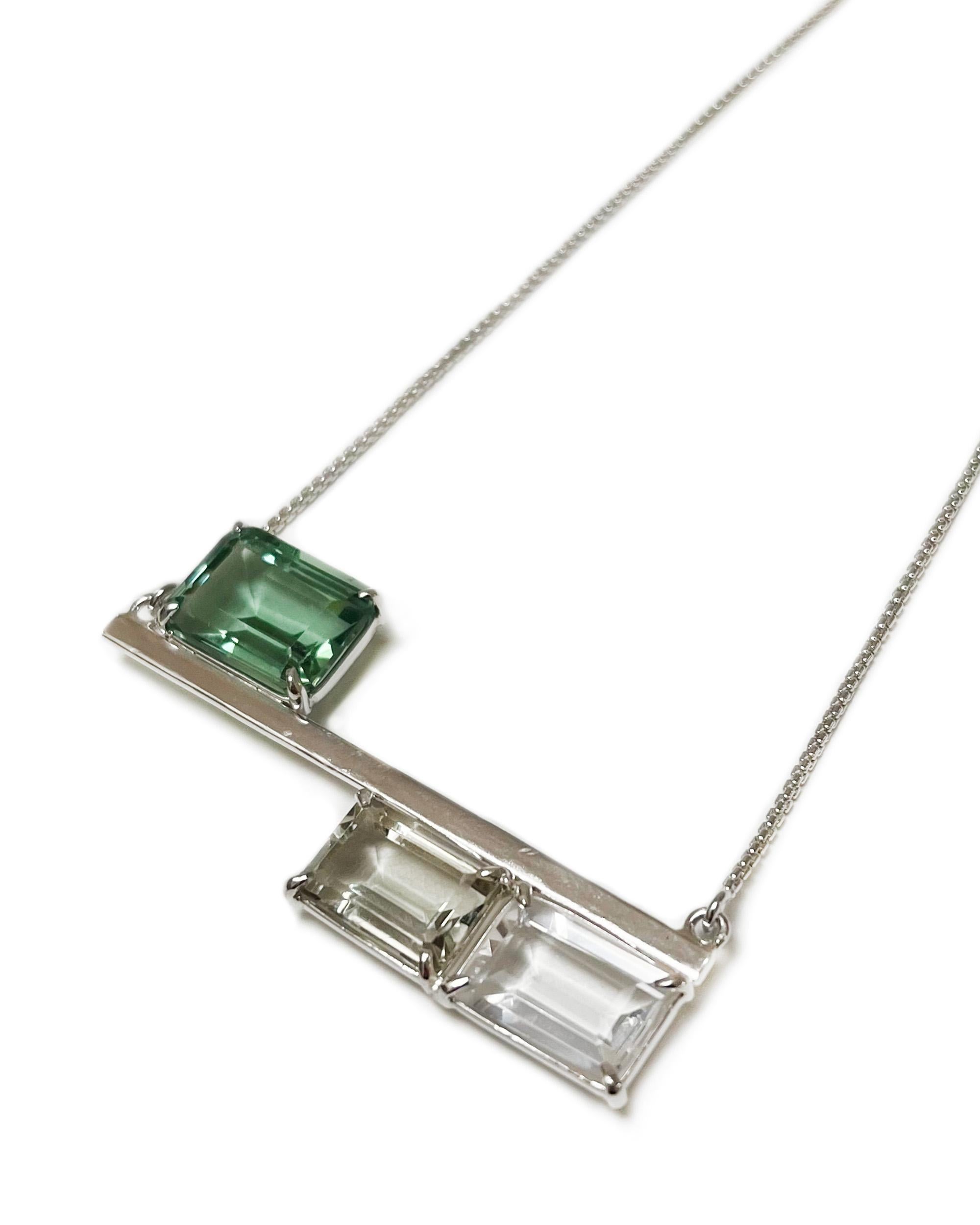 Intention: Balance

Design: This unique sterling silver bar necklace has three strategically placed stones in gradients of green. Emerald-cut green quartz transitions to soft green prasiolite and crisp white topaz, keeping your balances in check.