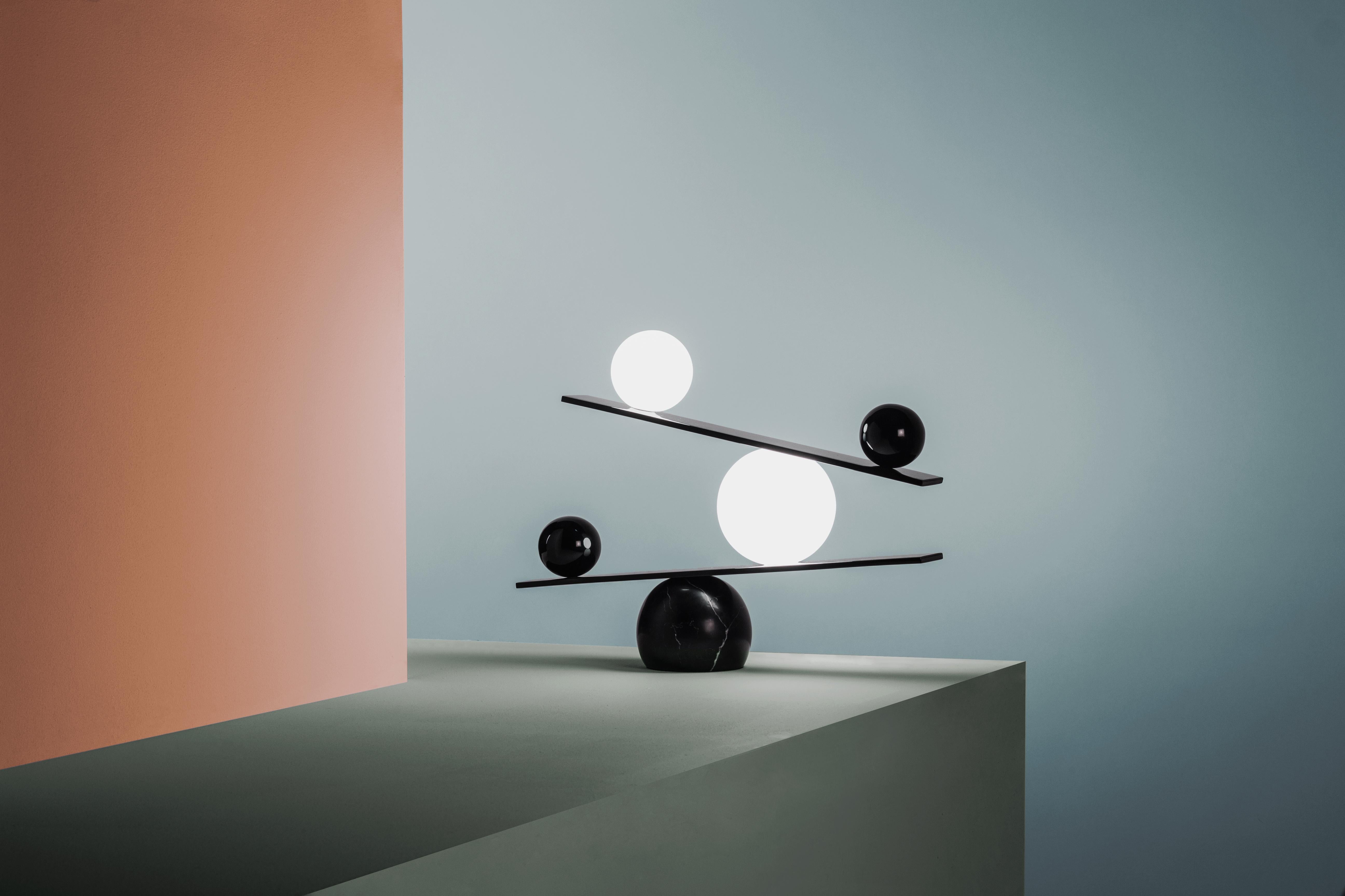 Balance table lamp by Victor Castanera.
Balance is a playful and curiosity evoking tribute to the concepts of gravity and time.
Dimensions: 40 (H) x 53.5 (L) x 13 cm
Materials: Glossy paint with marble base (also available in plated brass with