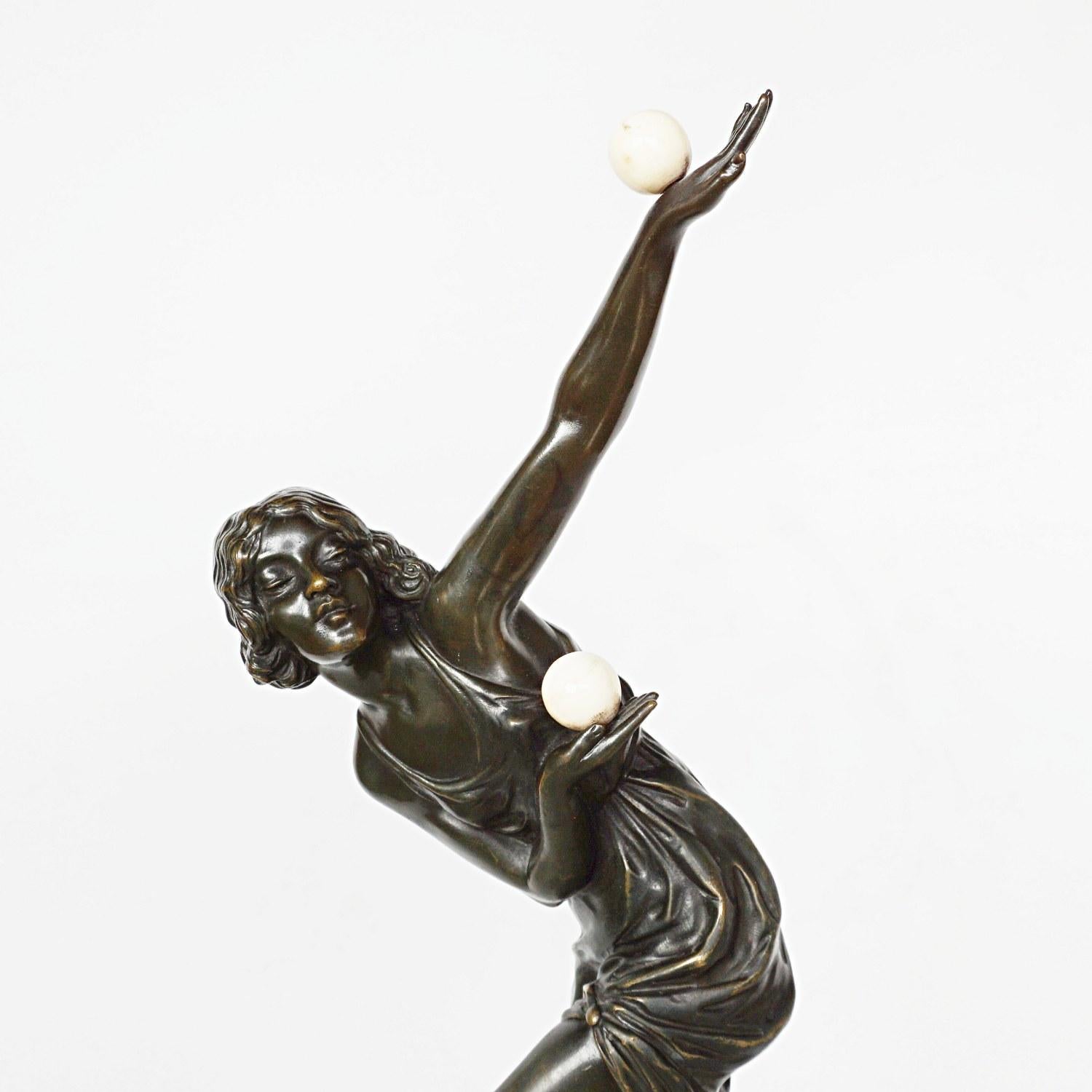 An Art Deco, patinated bronze and marble study of a dancer in stylised pose, juggling two marble balls and balancing on a slate ball, set over a slate base. By Marcel Bouraine.

Signed M Bouraine to plinth

 Marcel Andre Bouraine, French, 1886