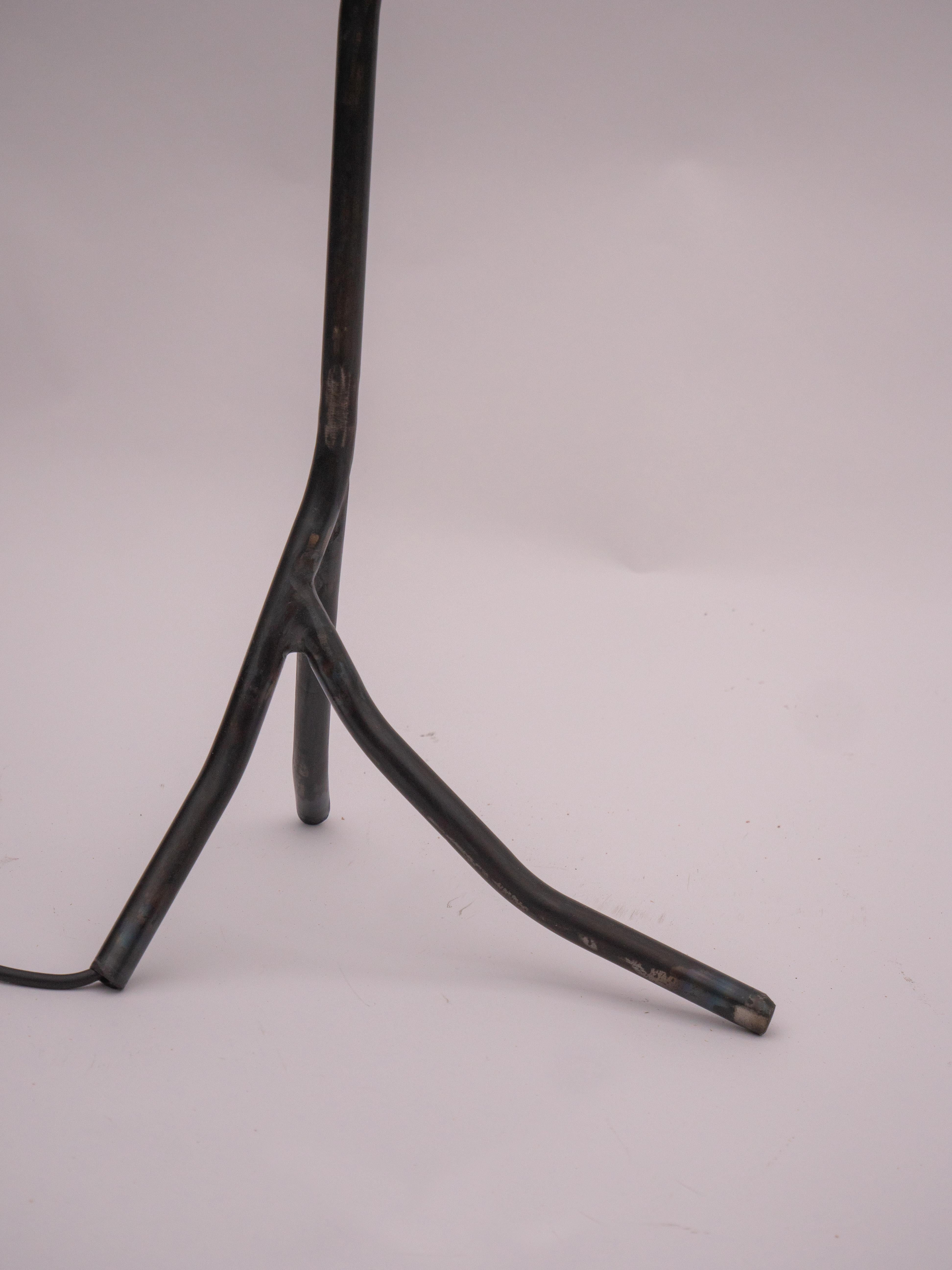 A welded Steel Table Lamp. Balancing Act is a collection of two lamps and a candle holder. Inspired by Calder’s Circus, it captures a sense of naive joy and playful freedom, inviting interaction and spontaneity through balanced forms and whimsical
