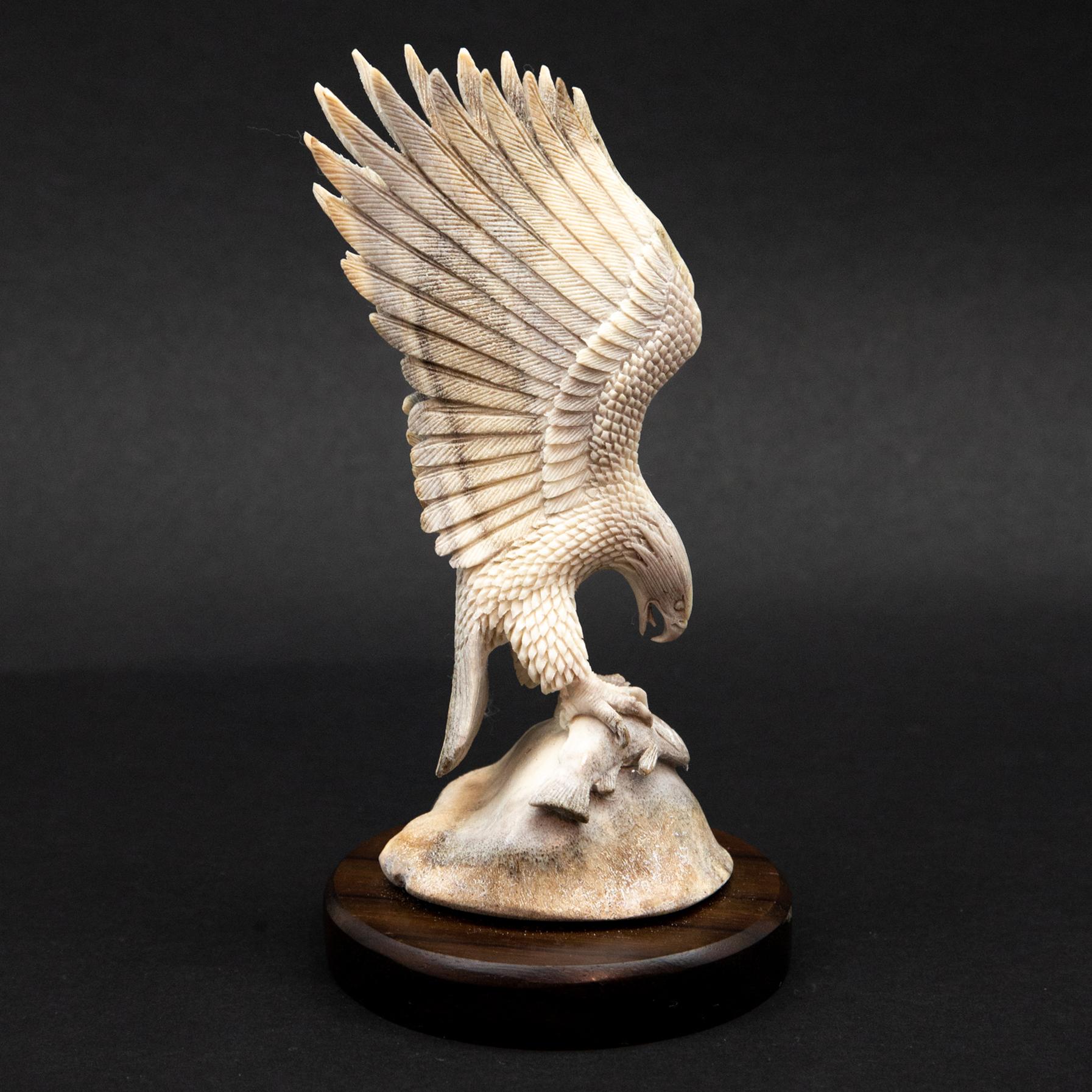 Bald Eagle with Fish Moose Antler Carving.  Detailed moose antler carving of a bald eagle holding a fish, from Indonesia. This is a one of a kind object. The moose antler was sourced in North America and then sent to Asia for carving. Quality of