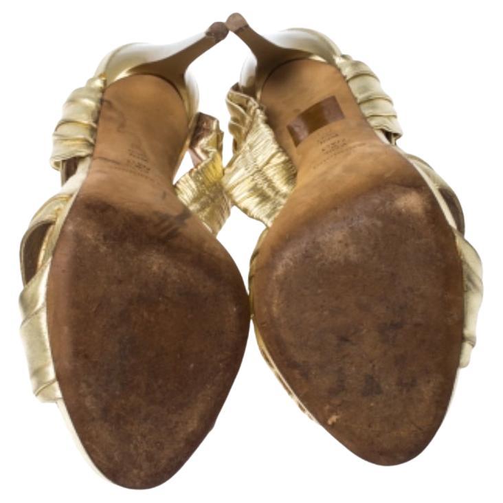 A beautifully draped pair of sandals to take you from light to night is this one from Baldinini. They are crafted from metallic gold leather and feature peep toes, elastic back straps and 11 cm heels. They are sure to add the right touch of glamour.