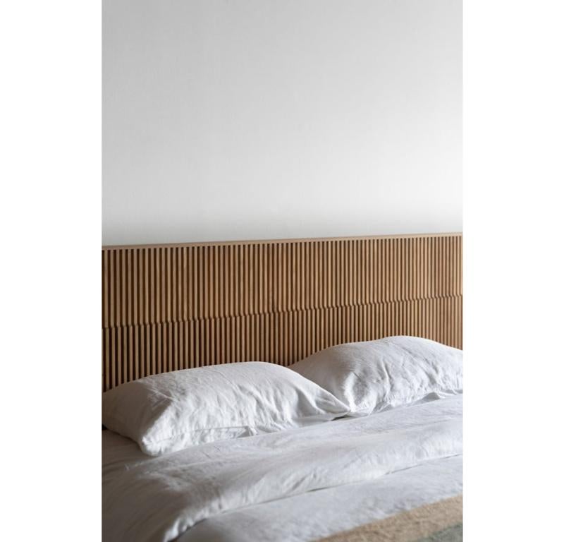 The Baldwin Bed is handmade locally in Los Angeles, California. The headboard is crafted by uniquely shaped oak pieces that are meticulously placed by hand. The oversized headboard provides the perfect backdrop for nightstands. The solid oak side