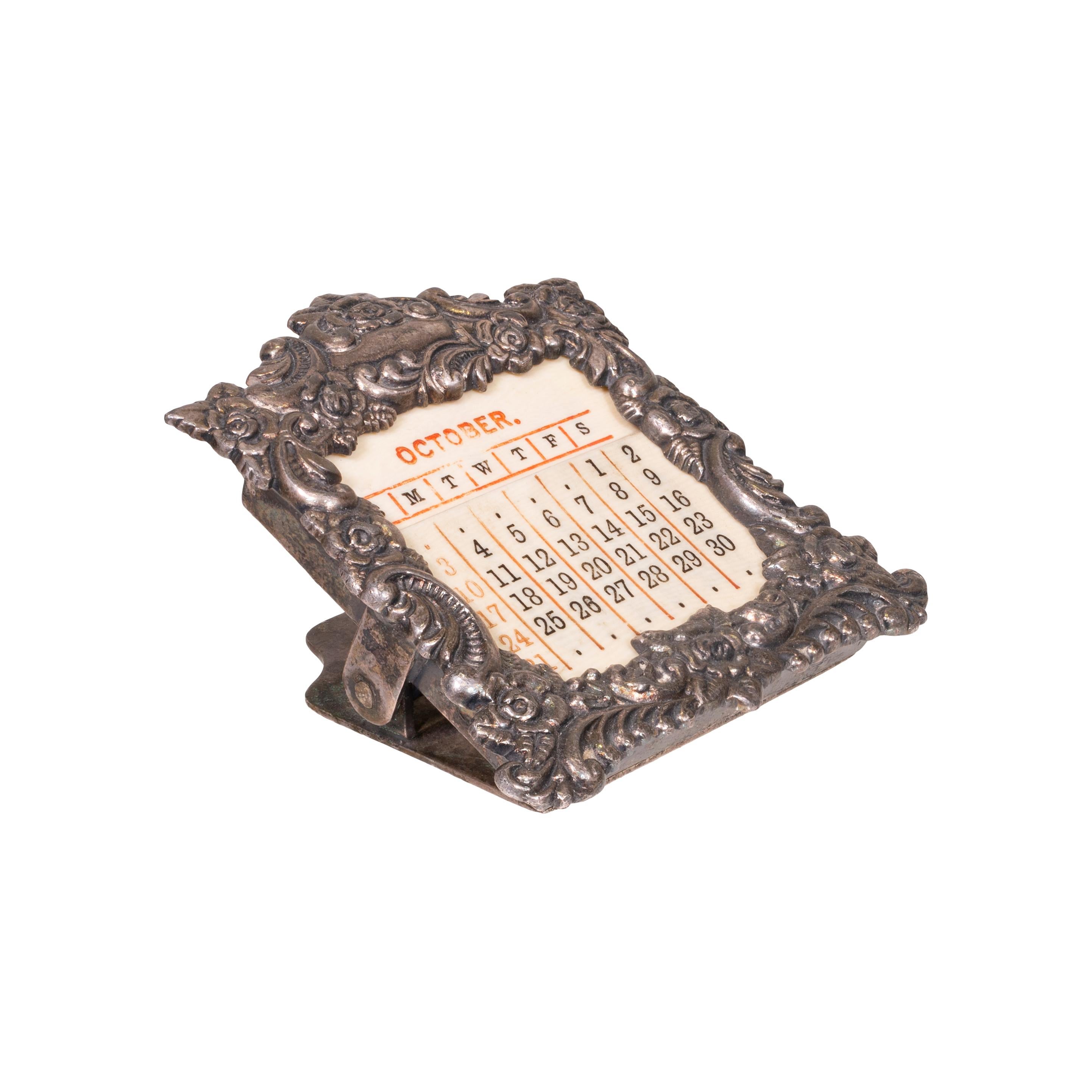 Small, pocket sized ornate silver plate Victorian perpetual calendar. Holder clip with ivory color celluloid cards that can be arranged for every month, every day, every year. Made by Baldwin & Gleason co. ltd, New York. Copyright 1893. Rare and