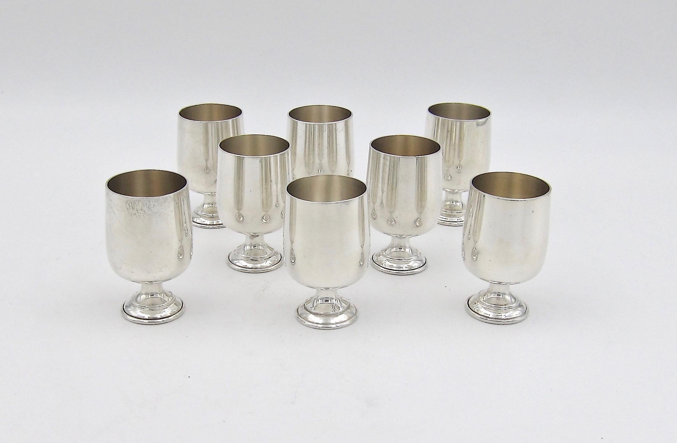 A vintage set of eight sterling silver cordial cups suitable for serving vodka or an aperitif from Baldwin & Miller, Inc. of Newark, NJ, dating, circa 1940s. Each cup looks like a small goblet supported by a circular pedestal foot. The cups bear no