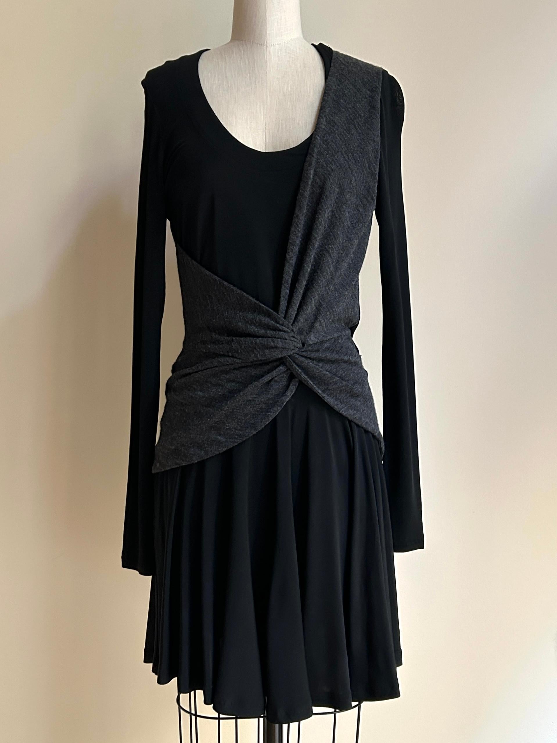 Balenciaga 2004 by Nicolas Ghesquiere black jersey dress features a charcoal wrap inspired by a ballerina's practice attire. Scoop neck, long sleeve.

95% acetate, 5% spandex. 
Grey wrap feels like wool blend. 

Made in Italy.

Size IT 38,