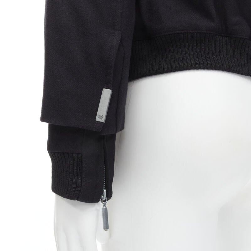 BALENCIAGA 2011 Ghesquiere black wool double sleeve bomber jacket EU44 XS
Reference: CNTG/A00008
Brand: Balenciaga
Designer: Nicolas Ghesquiere
Collection: 2011
Material: Wool
Color: Black
Pattern: Solid
Closure: Zip
Extra Details: Silver-tone stud