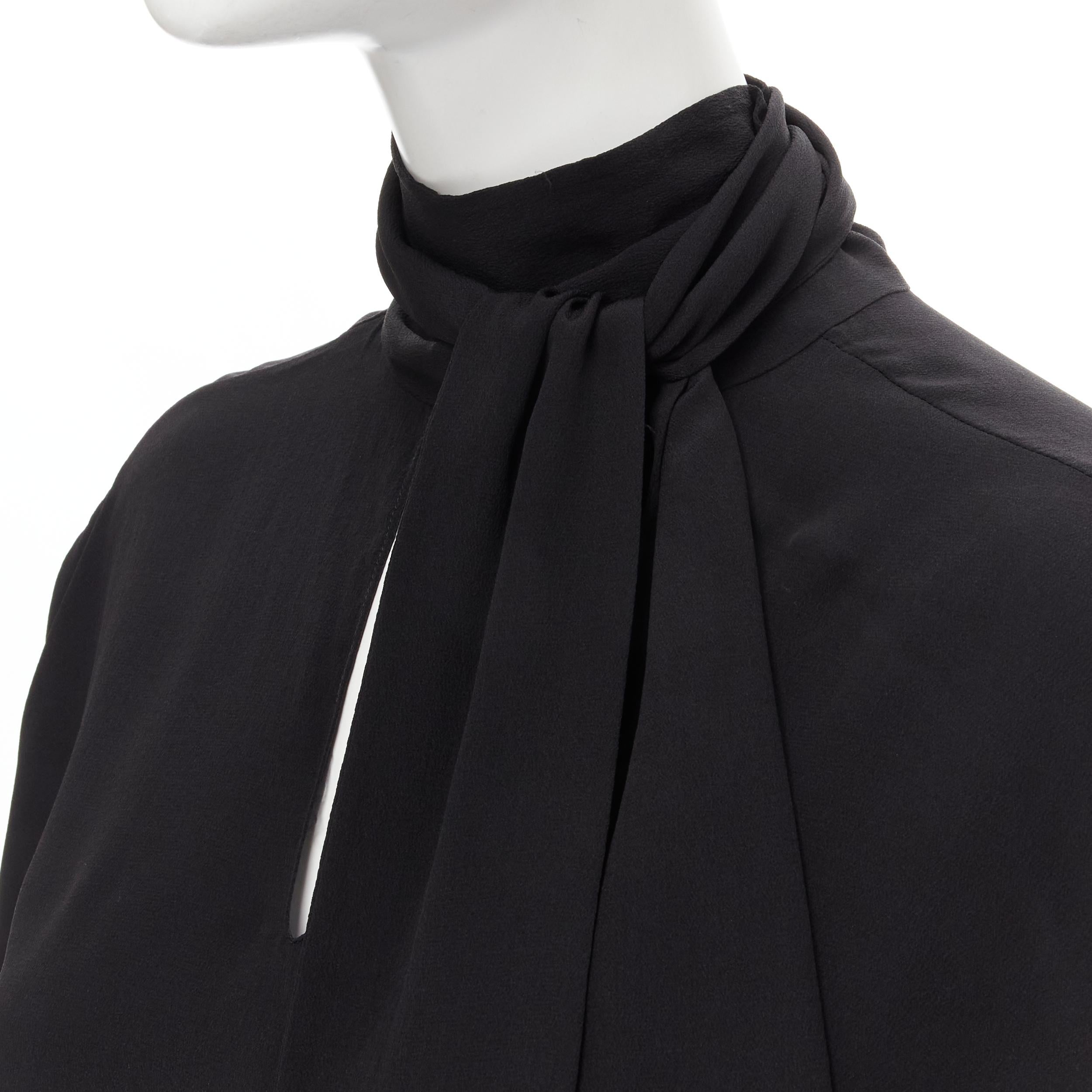 BALENCIAGA 2016 Archetype dipped back pussy bow silk blouse top FR34 XS 
Reference: MELK/A00123 
Brand: Balenciaga 
Designer: Demna 
Collection: 2016 
Material: Silk 
Color: Black 
Pattern: Solid 
Extra Detail: V-neck. Dipped back. Attached pussy