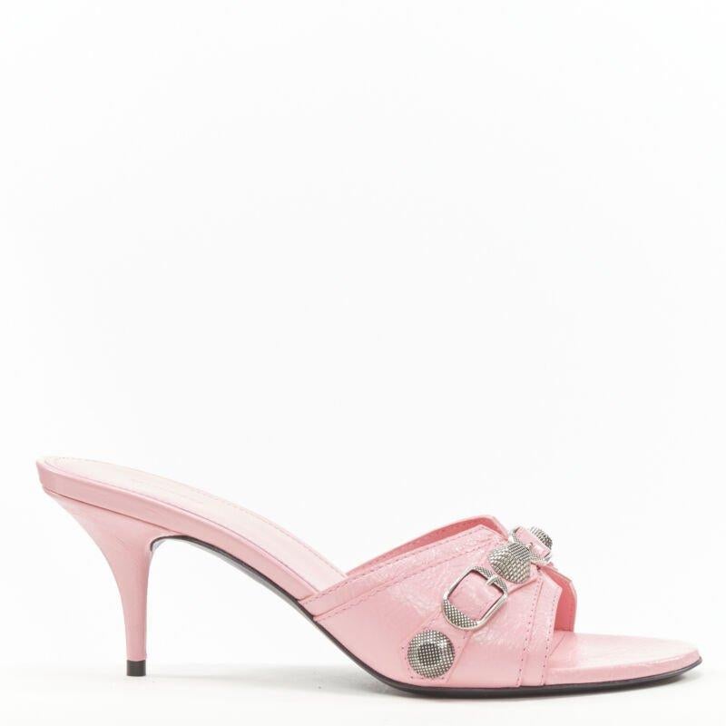 BALENCIAGA 2022 Cagole pink leather silver studded mule heel EU38 US8
Reference: TGAS/B02227
Brand: Balenciaga
Designer: Demna
Model: Cagole
Collection: 2022
Material: Leather, Metal
Color: Pink, Silver
Pattern: Solid
Lining:  Leather
Extra Details: