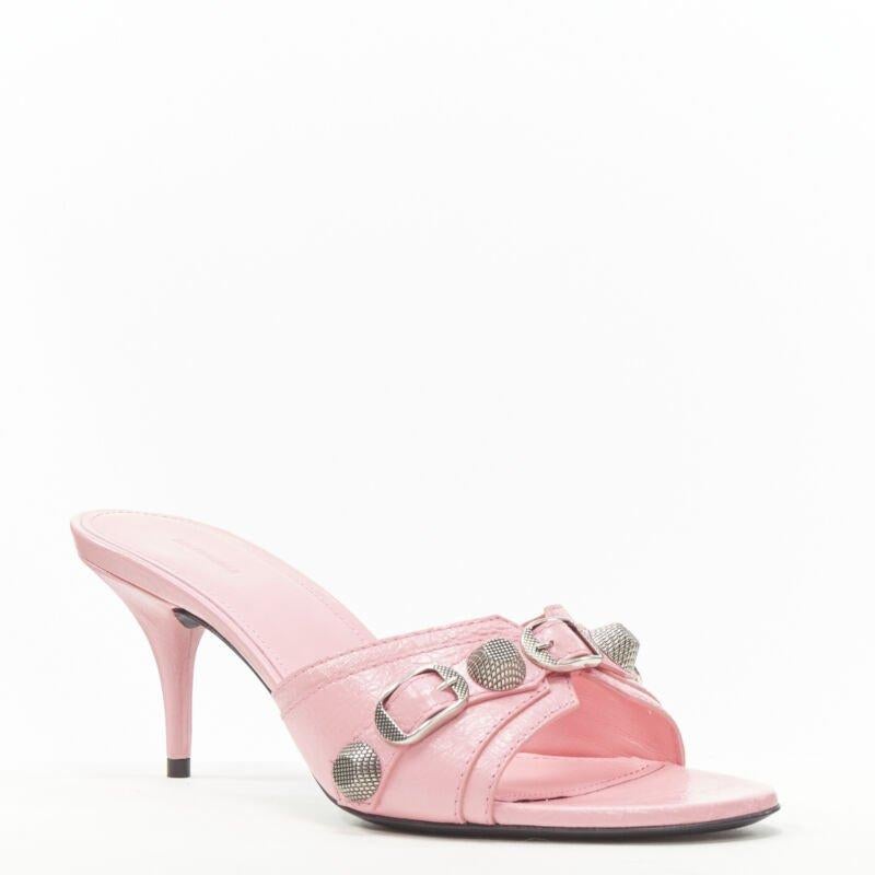 BALENCIAGA 2022 Cagole pink leather silver studded mule heel EU38 US8
Reference: TGAS/B02227
Brand: Balenciaga
Designer: Demna
Model: Cagole
Collection: 2022
Material: Leather, Metal
Color: Pink, Silver
Pattern: Solid
Lining:  Leather
Extra Details: