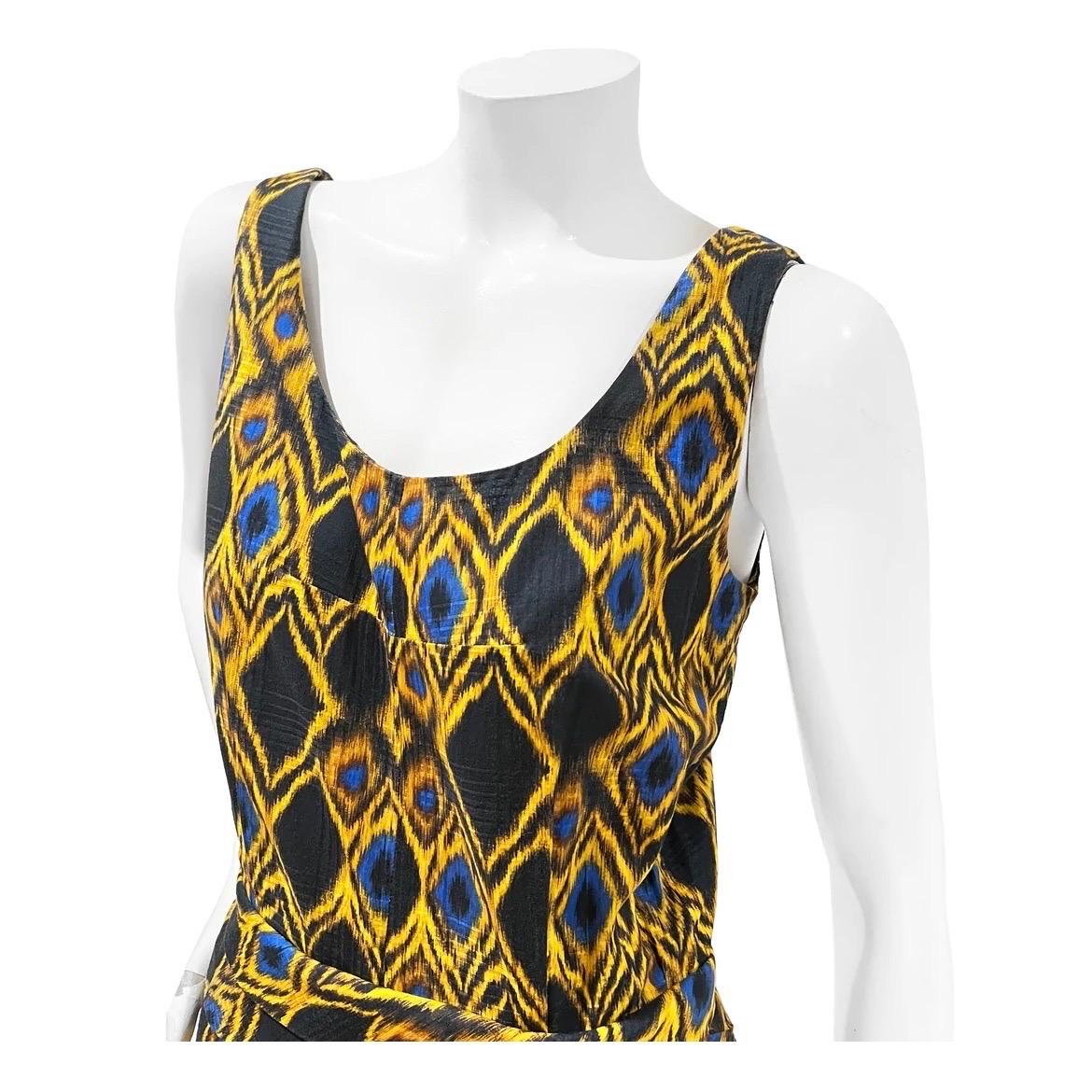Abstract Print Dress by Balenciaga
Circa 2009
Made in France
Black with yellow/blue abstract print design
Sleeveless  
Invisible back zip closure
Pleated detail on skirt
Scoop neckline
Layered fabric belt detail
Belt has multi clasp closure in