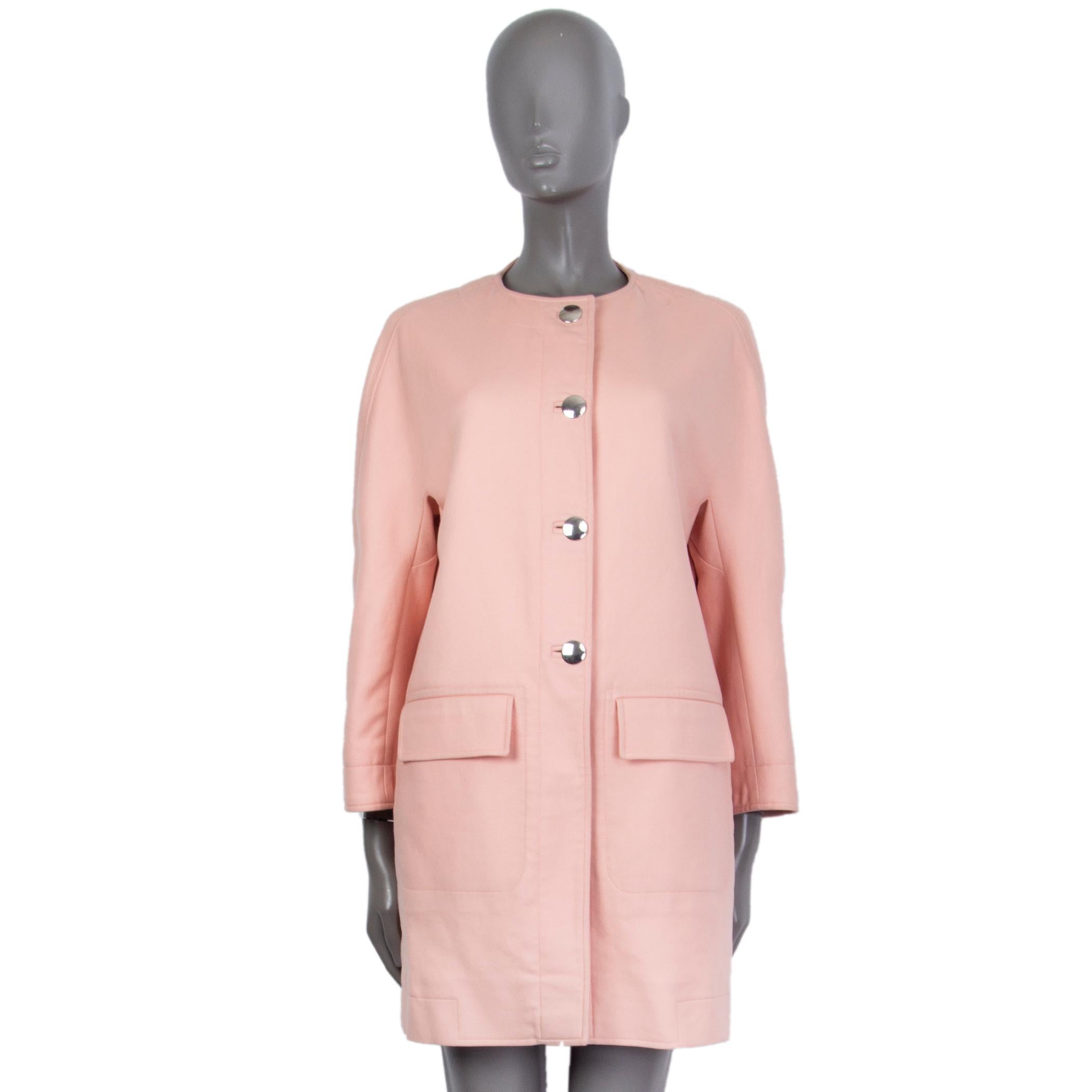 100% authentic Balenciaga collarless transition coat in baby pink cotton (100%) with slit pockets on the sides. Has two frontal docorative flap pockets. Closes on the front with silver tone buttons. Lined in acetate (72%) and elastodien (28%). Has