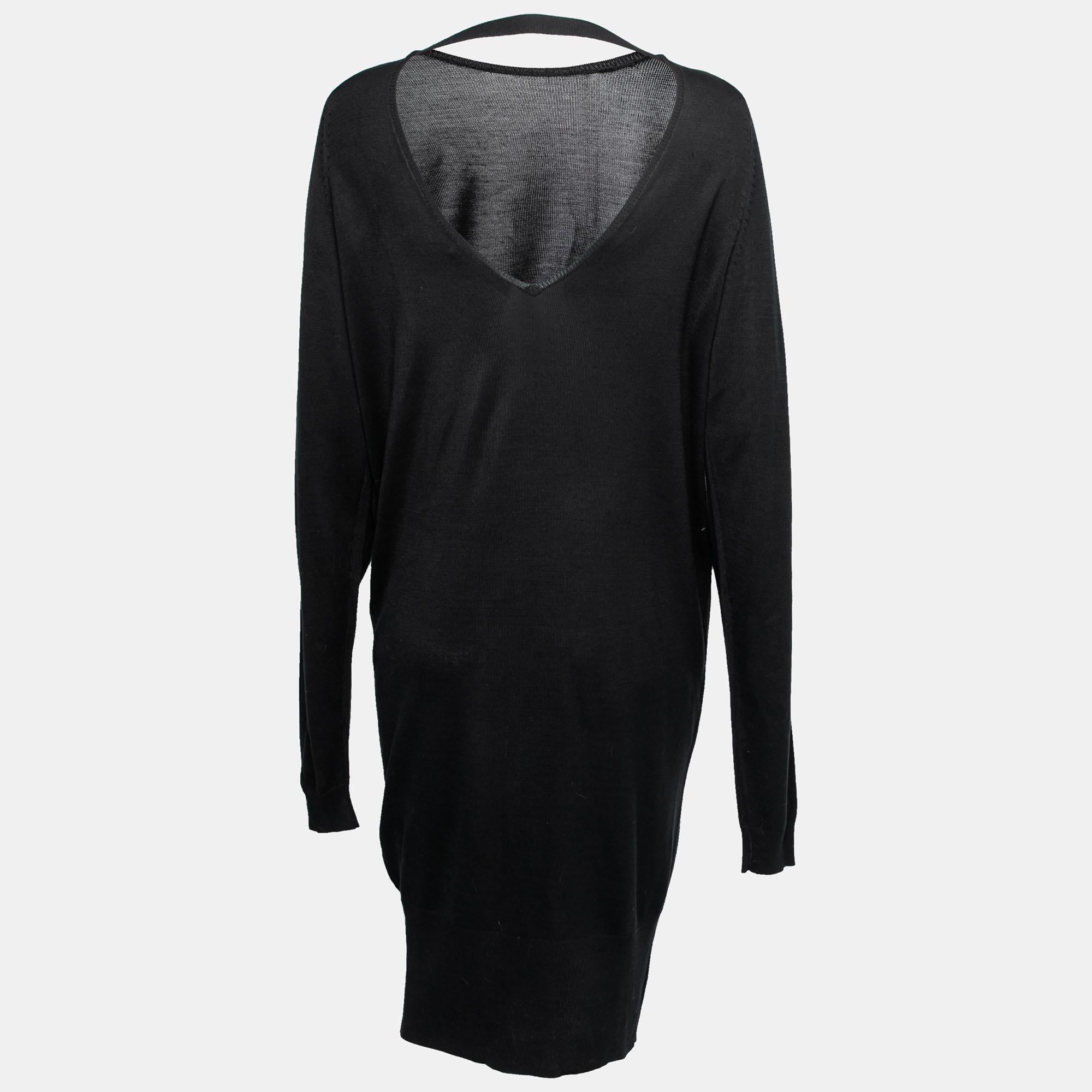 With this dress from the House of Balenciaga, comfort and elegance come easy! It is fashioned in black silk knit fabric and flaunts a low-cut backline, long sleeves, and embellishments on the shoulder. Match this Balenciaga dress with matching heels