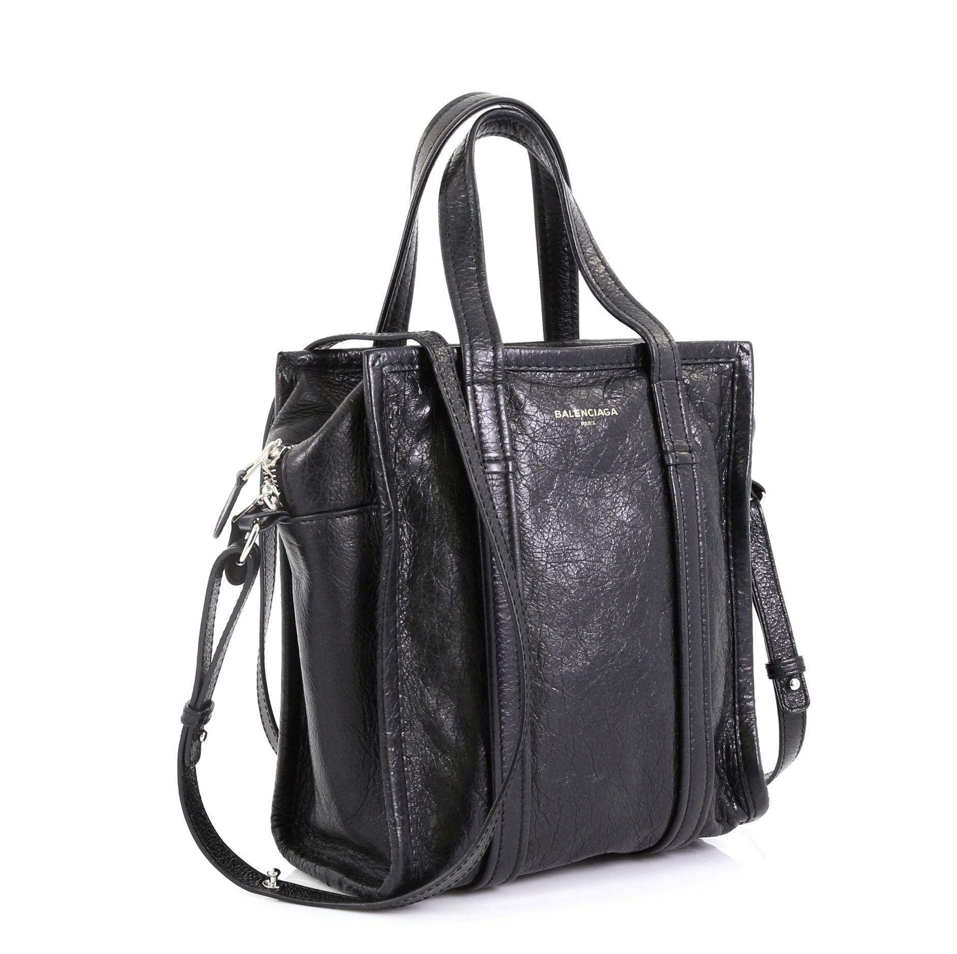 This Balenciaga Bazar Convertible Tote Leather XS, crafted in black leather, this bag features dual top leather handles, and silver-tone hardware accents. Its zip closure opens to a black fabric-lined interior with zip pocket 

Estimated Retail
