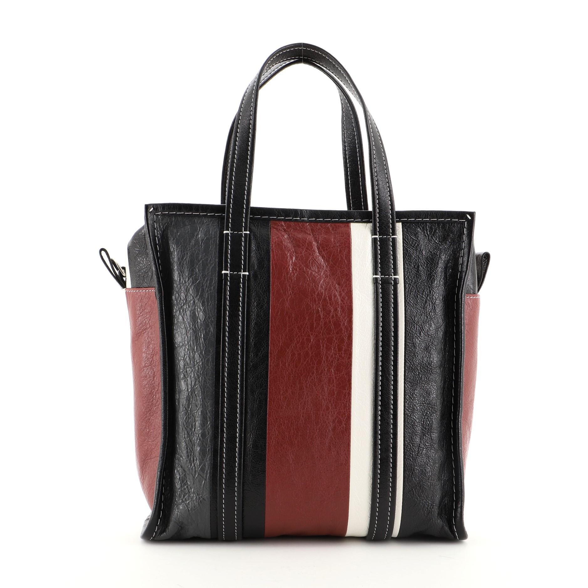 Balenciaga Bazar Convertible Tote Striped Leather Small
Black Red Striped Leather

Condition Details: Creasing on exterior and handles, small glue stains on base, heavy discoloration on opening trim, scratches on hardware.

44845MSC

Height 11