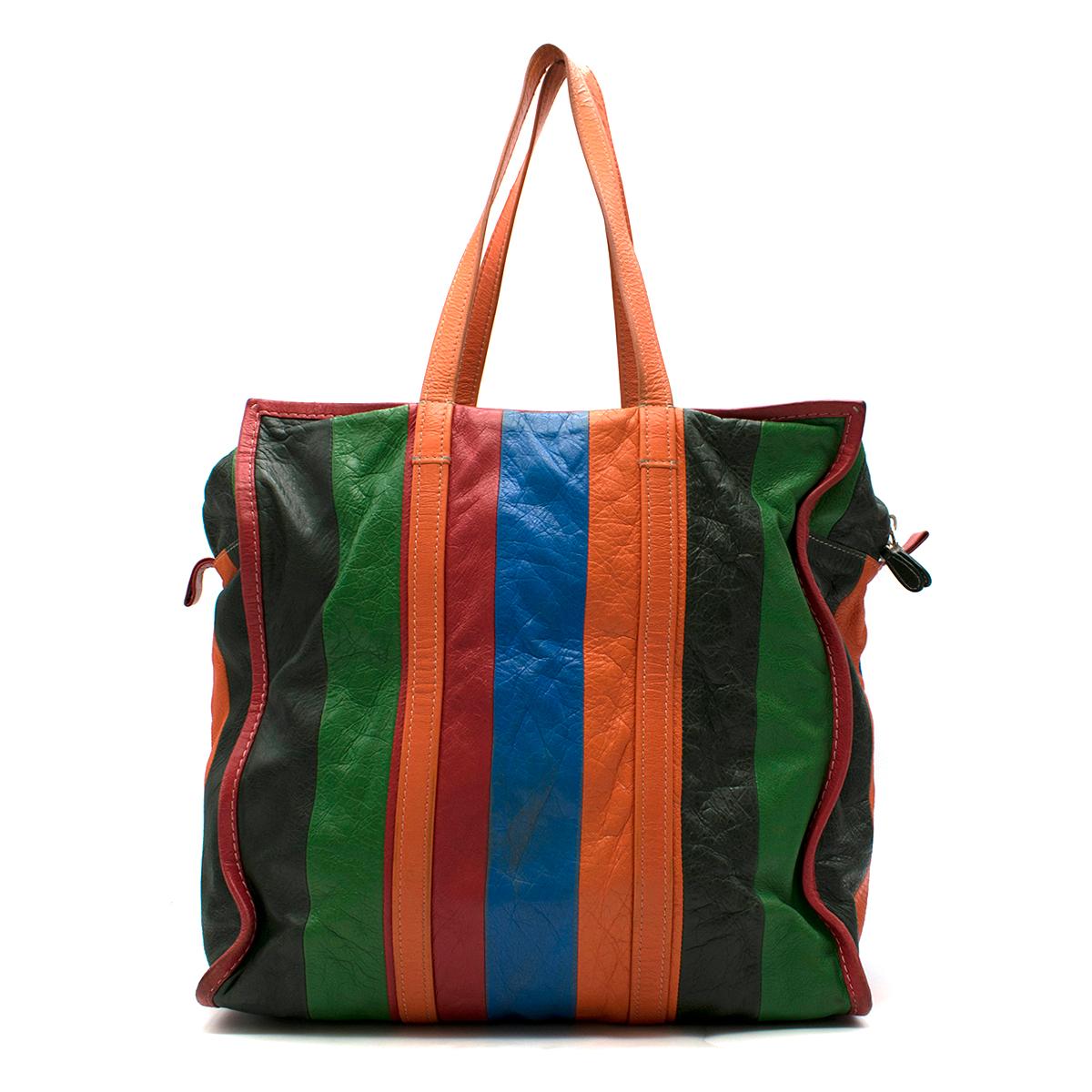 Balenciaga Bazar Shopper Tote Bag 

- Mid-weight, multi-coloured leather shopper tote bag
- Orange straps
- Silver-tone zip fastening
- Two interior pockets
- This item comes with the original dust bag. 

Please note, these items are pre-owned and