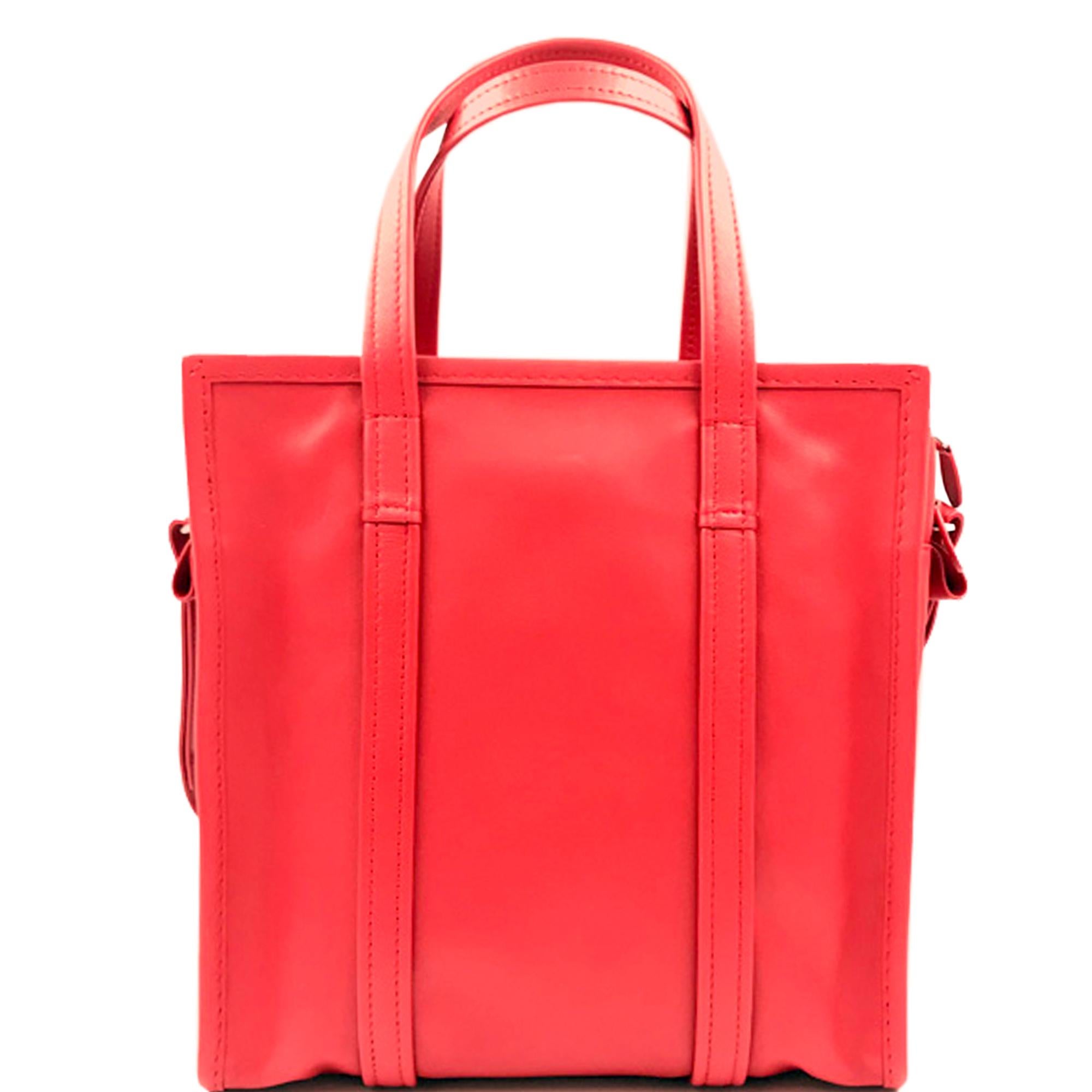 Balenciaga's coveted Bazar shopper arrives in red and an S size. It's made in Italy from naturally creased leather with a detachable shoulder strap, silver-tone metal hardware and opens to reveal an internal slip pocket and four card holders. Carry