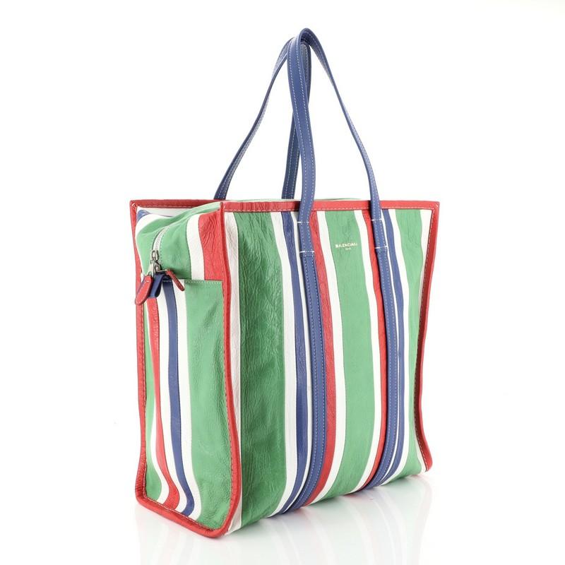 This Balenciaga Bazar Tote Striped Leather Medium, crafted in green, red and multicolor striped leather, features dual flat leather handles and silver-tone hardware. Its zip closure opens to a black fabric interior with zip and slip pockets.