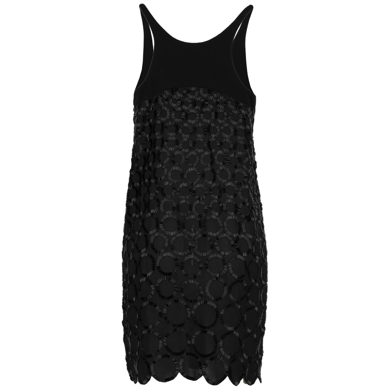 Sparkle your way into the room with this sleeveless Balenciaga Bead Embellished Black Dress. With beads stitched close to each other to create a circular design, the dress features a symmetrical hem in-line with the circles and a center waist patch