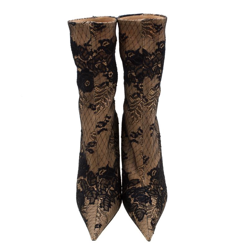 Balenciaga made these boots to delight the tastes of all fashion-forward ladies. These pointed toe boots are designed in a sock style using beige fabric and adorned with a black lace overlay. These are elevated on 12 cm heels, are comfortable and