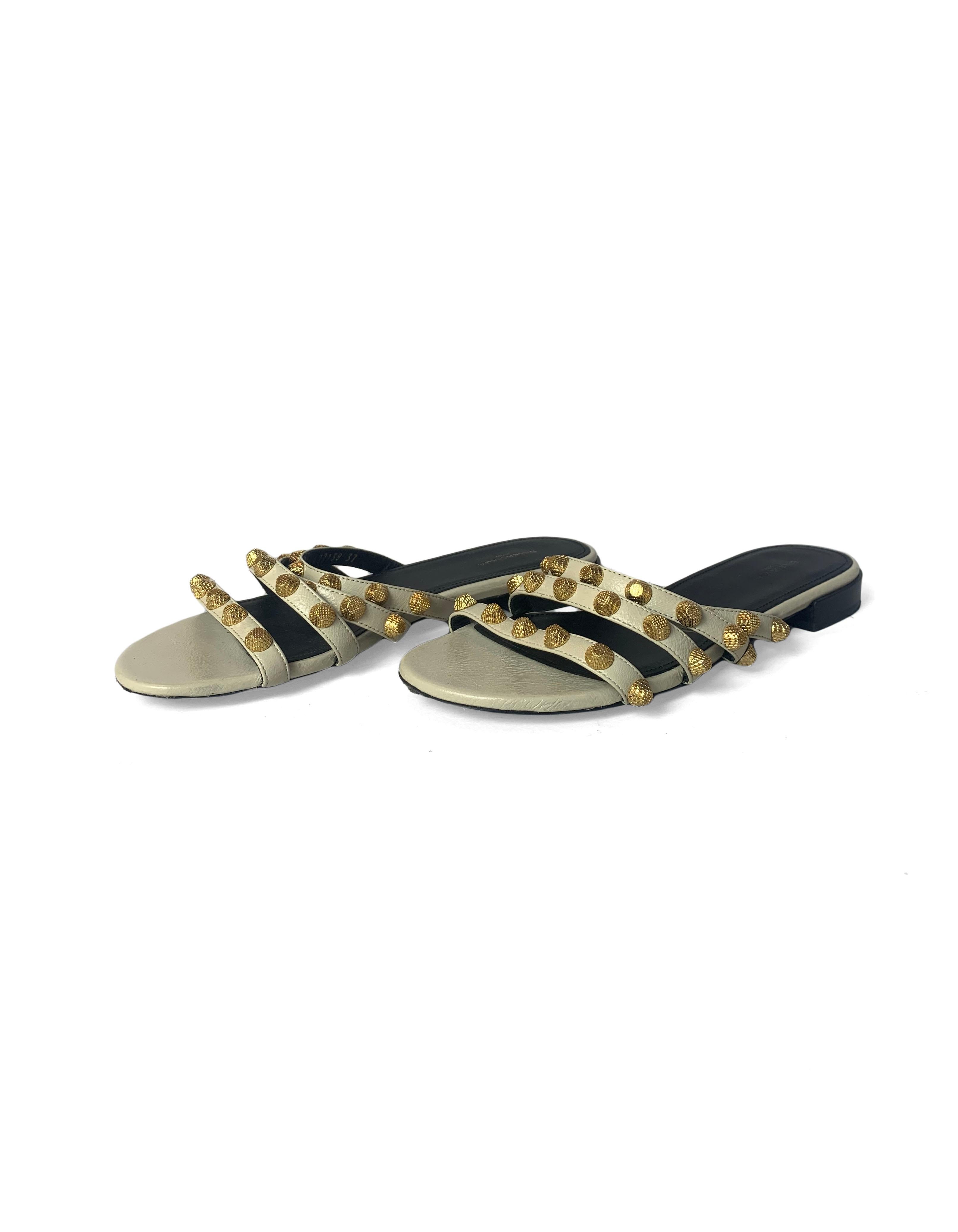Balenciaga Beige Leather and Goldtone Studded Slide Sandals sz 37

Made In: Italy
Color: Beige and gold
Hardware: Goldtone
Materials: Leather and metal
Closure/Opening: Slip on
Overall Condition: Excellent pre-owned condition with the exception of