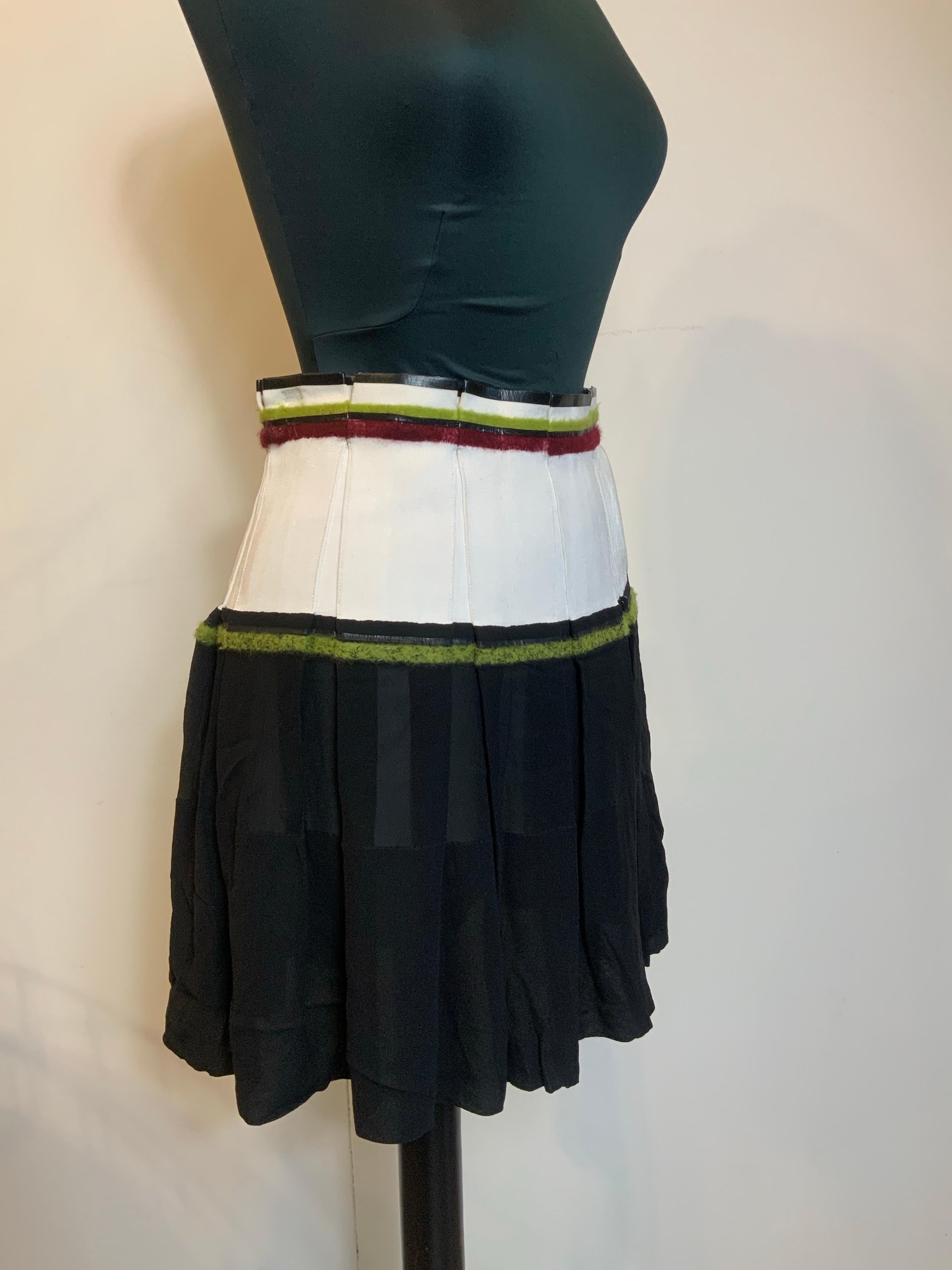 White and black Balenciaga skirt.
Featuring light green and burgundy details. 
The black fabric is semi-transparent.
Composition label missing.
We think it's cotton and silk.
French size 36 which corresponds to an Italian 40.
Length 46 cm
Waist 35