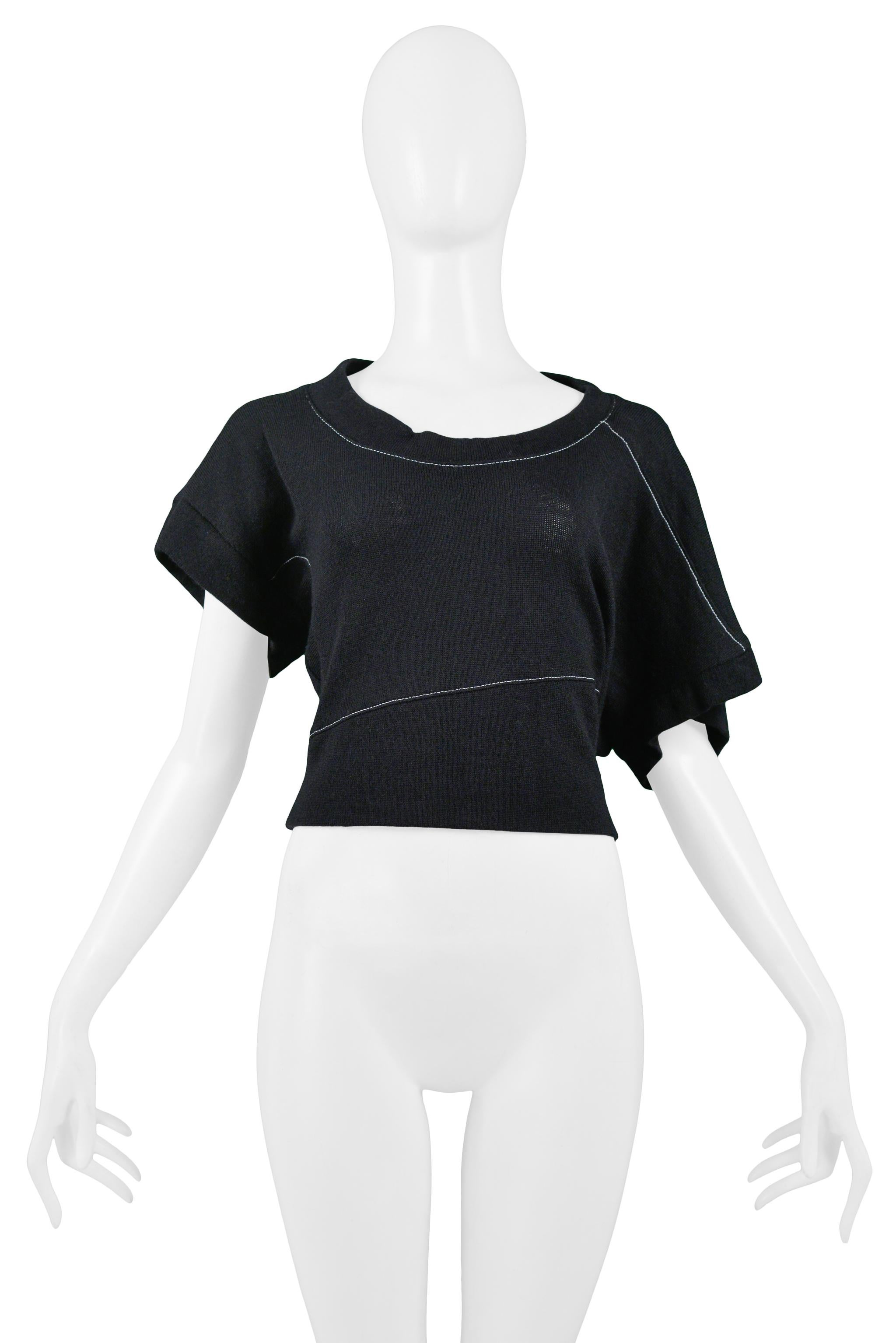Vintage Balenciaga by Nicolas Ghesquiere black wool short sleeve sweater featuring contrasting white stitching, a scoop neckline, and asymmetrical sleeves. 2002 Collection. 
Balenciaga Label
Designed By Nicolas Ghesquiere
Size 42
100% Wool
2002