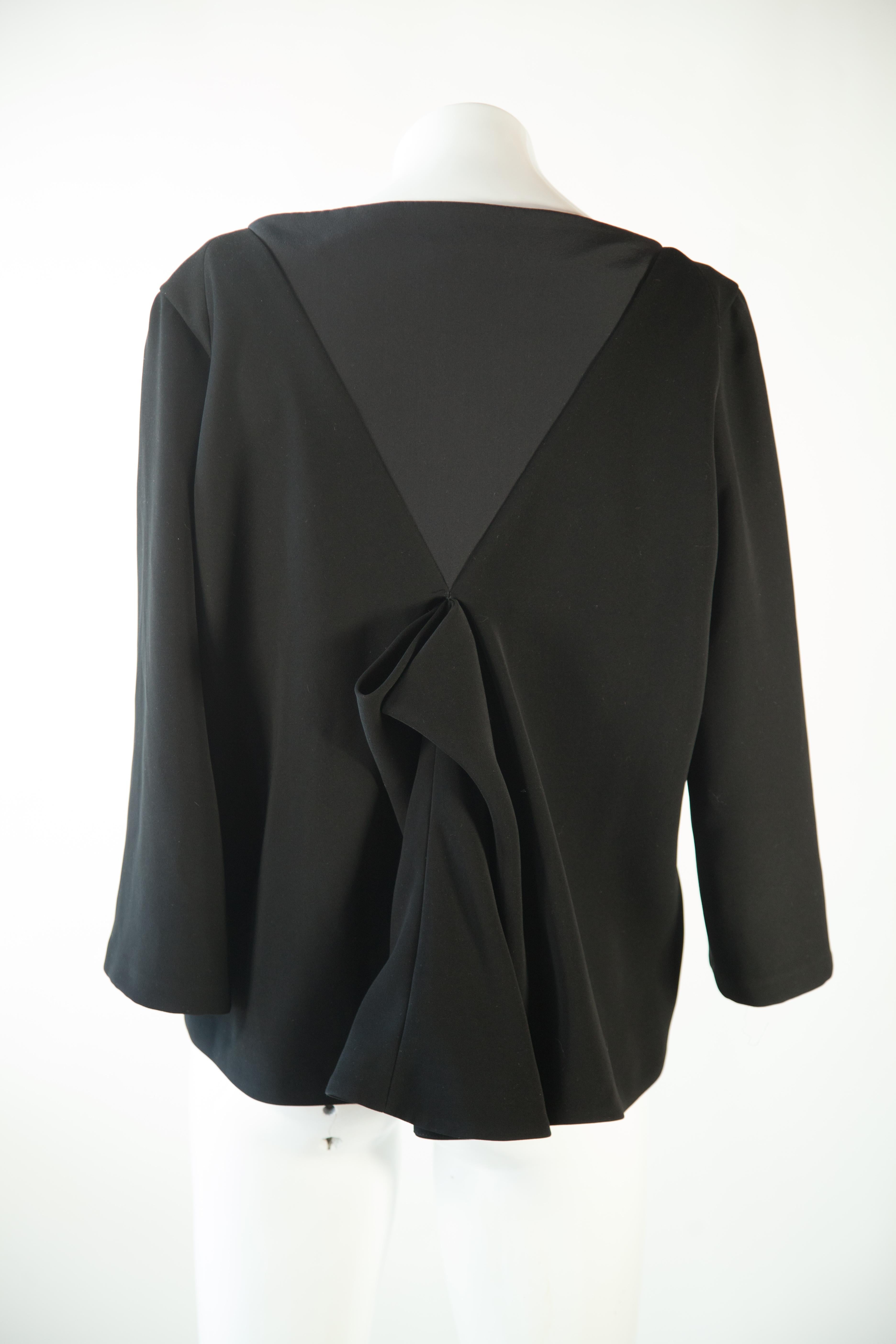 This Balenciaga classic black blouse features an elegant 3/4 sleeve detail and size 42 fit. Its timeless style and quality construction make it perfect for any formal occasion.