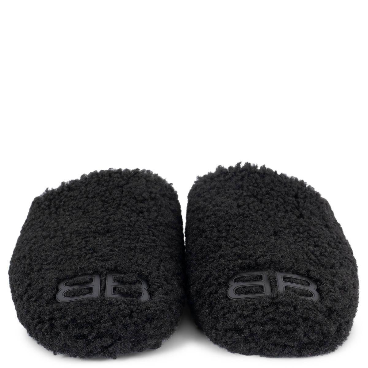 100% authentic Balenciaga Cosy BB slippers in black faux shearling with BB logo on tip. Have been worn once and are in virtually new condition. Come with dust bags. 

Measurements
Imprinted Size	38
Shoe Size	38
Inside Sole	25.5cm (9.9in)
Width	8cm
