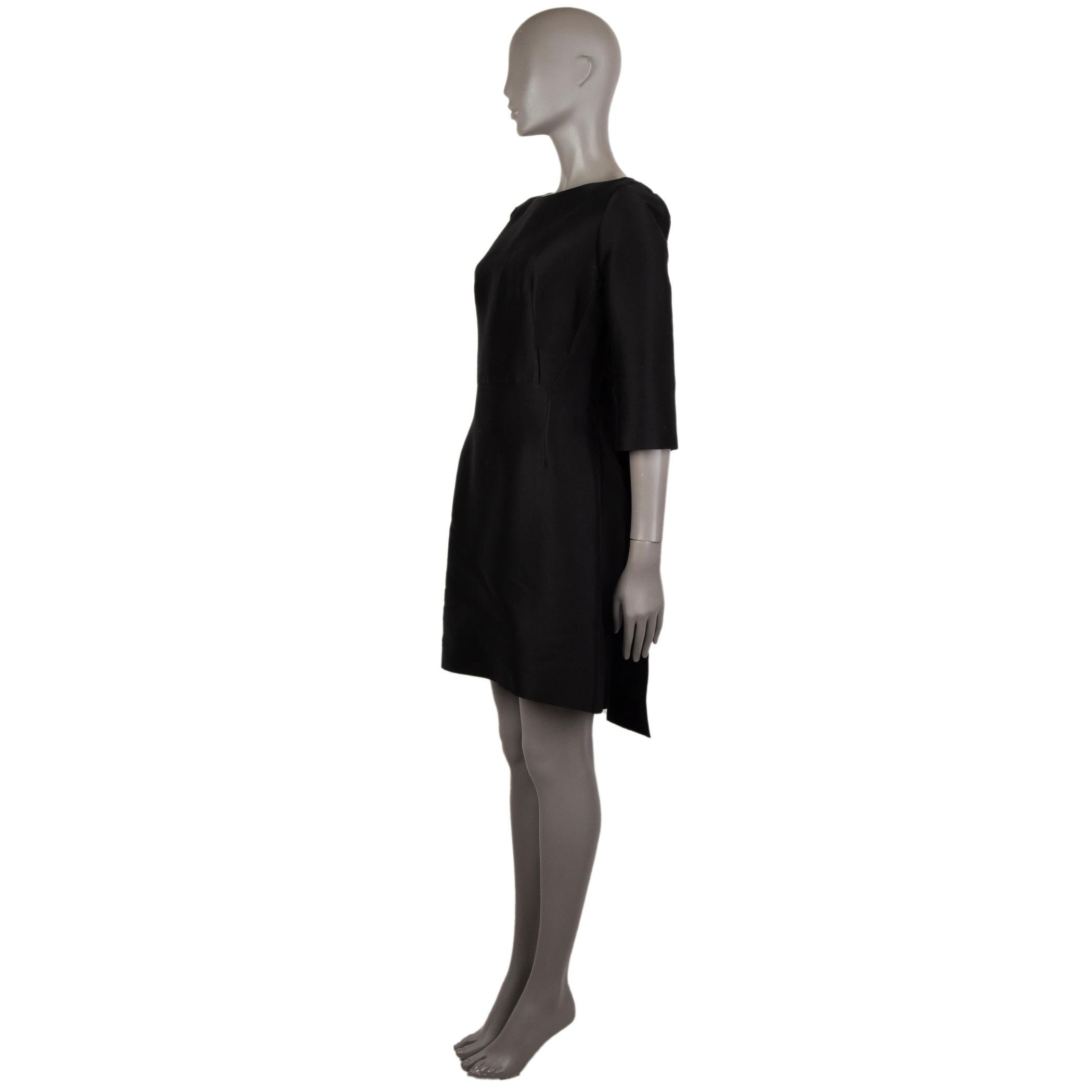 100% authentic Balenciaga 3/4-sleeve sheath dress in black cotton (88%) and silk (12%). With two pleated train flaps on the back of the skirt. Closes with hook and invisible zipper on the back. Unlined. Has been worn and is in excellent