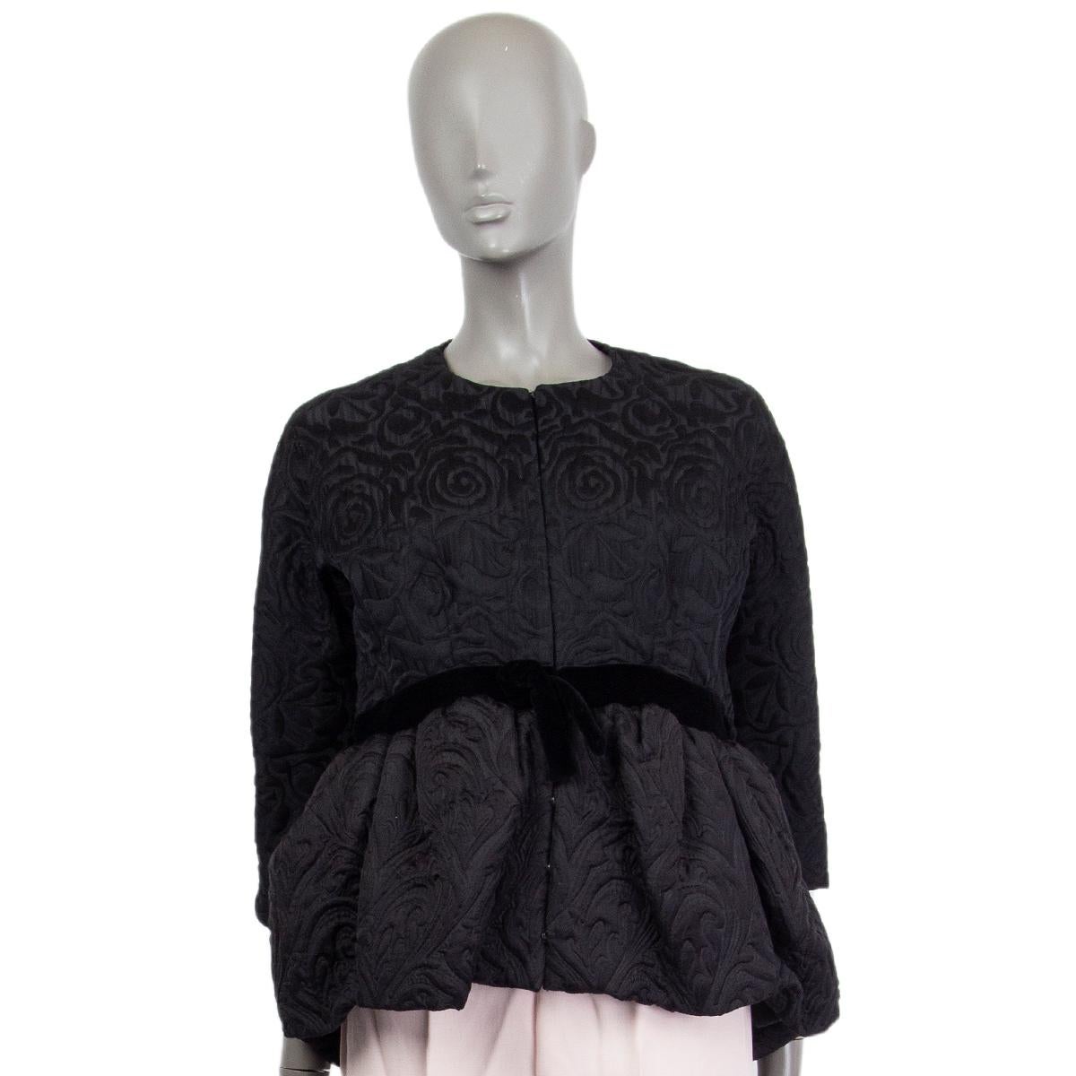 100% authentic Balenciaga peplum jacquard jacket in black cotton (43%), wool (42%) and silk (15%) with velvet waist band. Closes with concelead hooks and snaps. Lined in silk (100%). Raglan sleeves (sleeve measurement taken from the neck). Has been