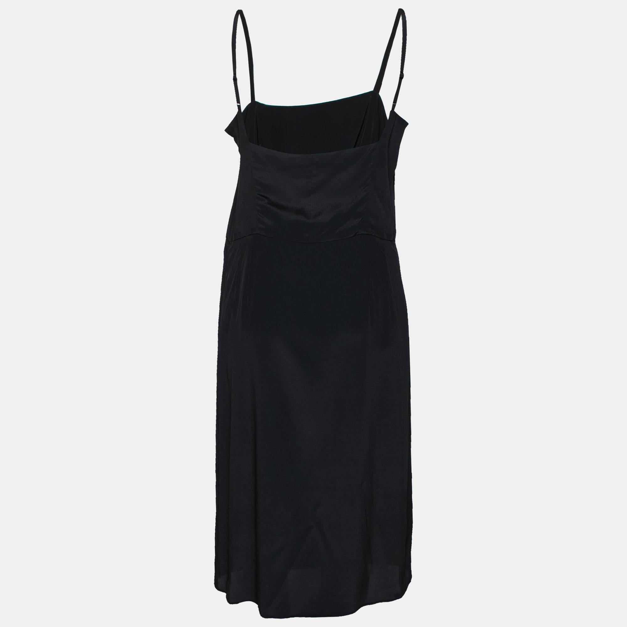 Sport a comfy and chic style as you wear this slip dress from the House of Balenciaga. Tailored from black crepe fabric, this dress is highlighted with slim and adjustable shoulder straps. It is provided with a zipper for fastening. Match this cute