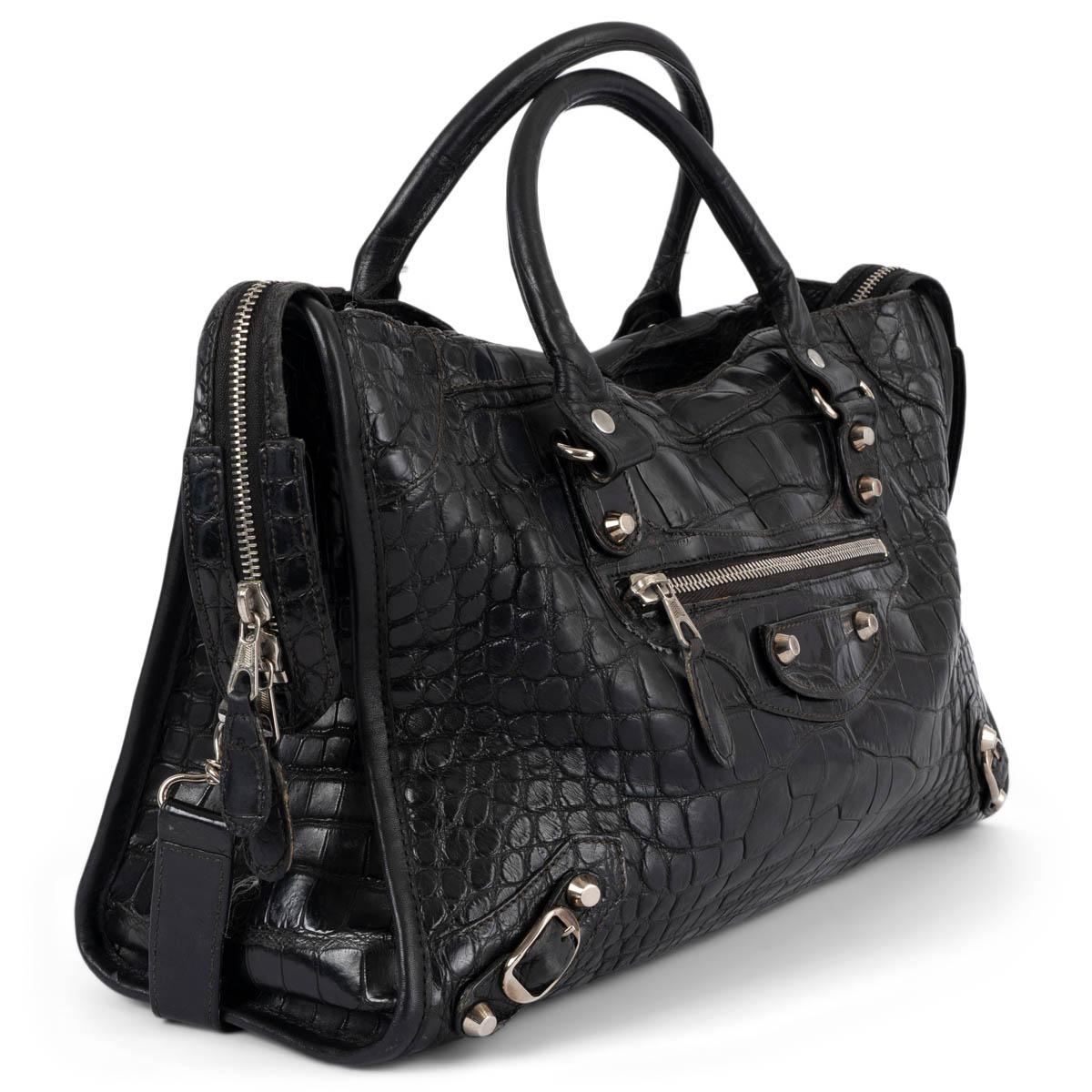 100% authentic Balenciaga Classic City bag in black matte crocodile. Opens with zipper on top and is lined in black canvas with one zip pocket against the back. Designed with a exterior front zip pocket, rolled handles and a detachable