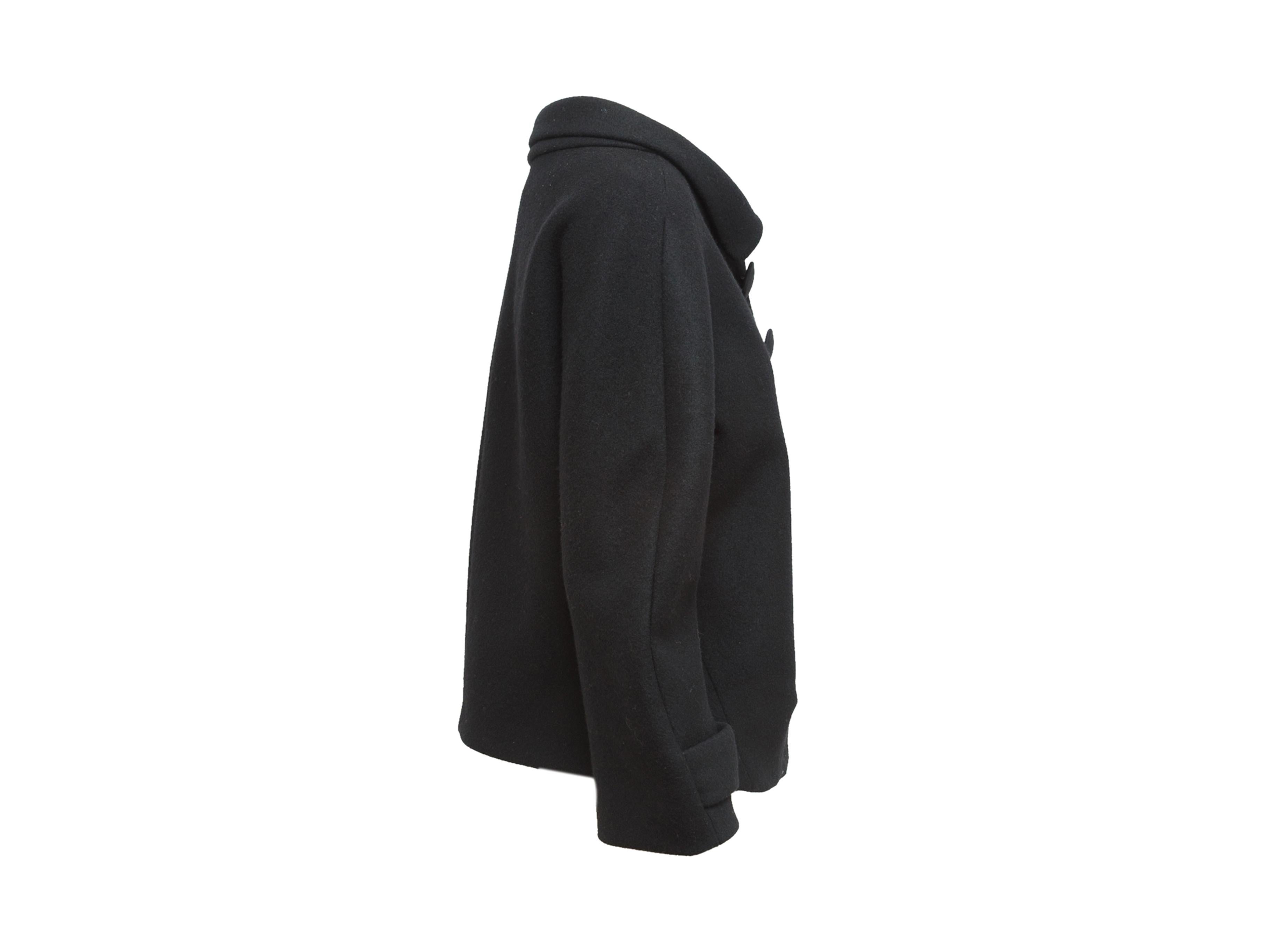 Product details: Black wool jacket by Balenciaga. From the Nicolas Ghesquière Fall/Winter 2006 Collection. Pointed collar. Long sleeves. Button closures at front. Designer size FR38. 40