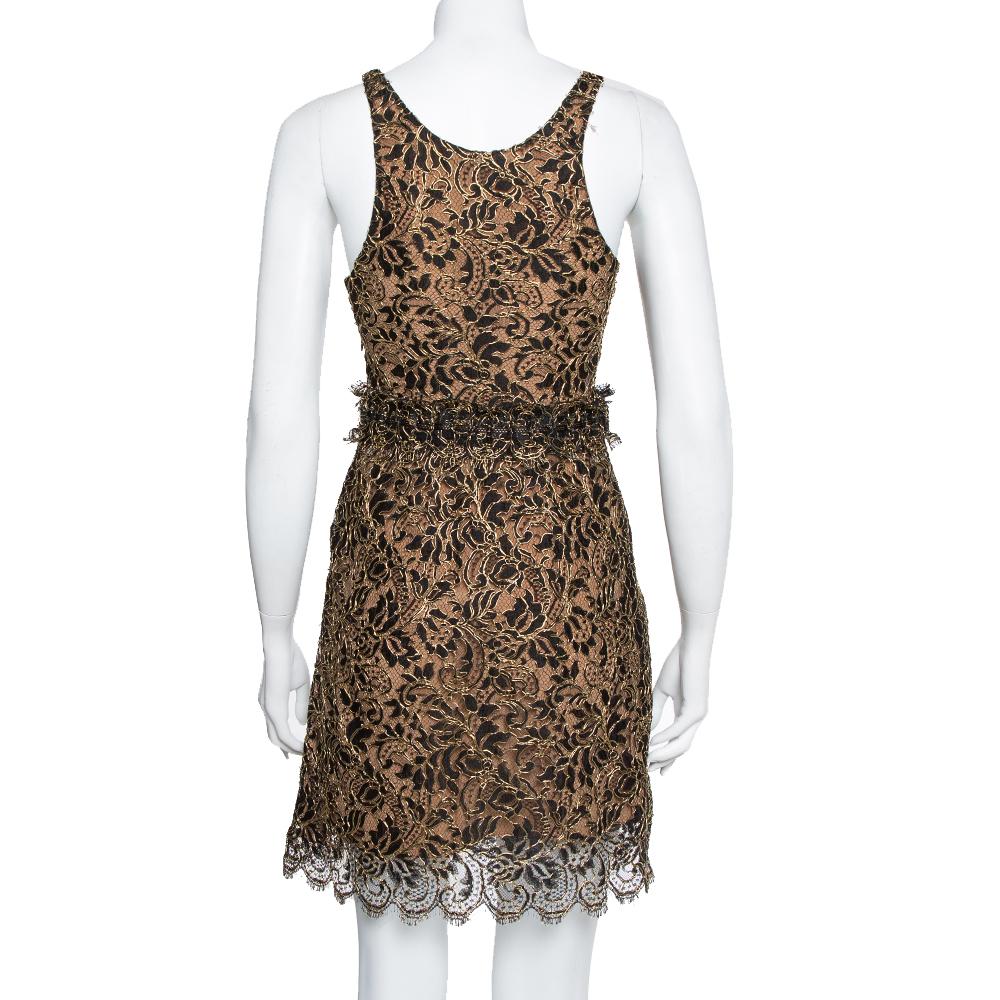 A sleeveless mini dress with a lace overlay makes up the final design of this Balenciaga creation. Beautiful in black and gold, the dress has a defined waistline, a scalloped hemline, scoop neckline, and zip closure.

