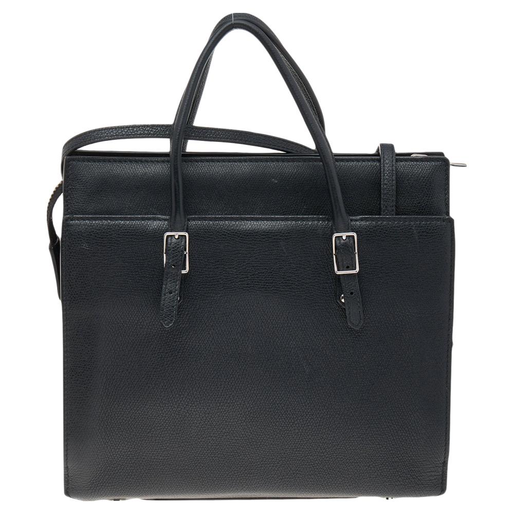 This Balenciaga tote is finely crafted using leather and fitted with dual top handles. It can be hand-held or used cross-body by attaching the shoulder strap. It has a spacious lined interior and the brand logo at the front.

Includes: Mirror,