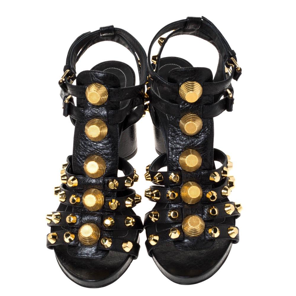 These stunning black sandals by Balenciaga are a bold style statement. Crafted from leather, they come in black. These gladiator-style sandals feature straps embellished with gold-tone studs, buckle closure, block heels, and leather
