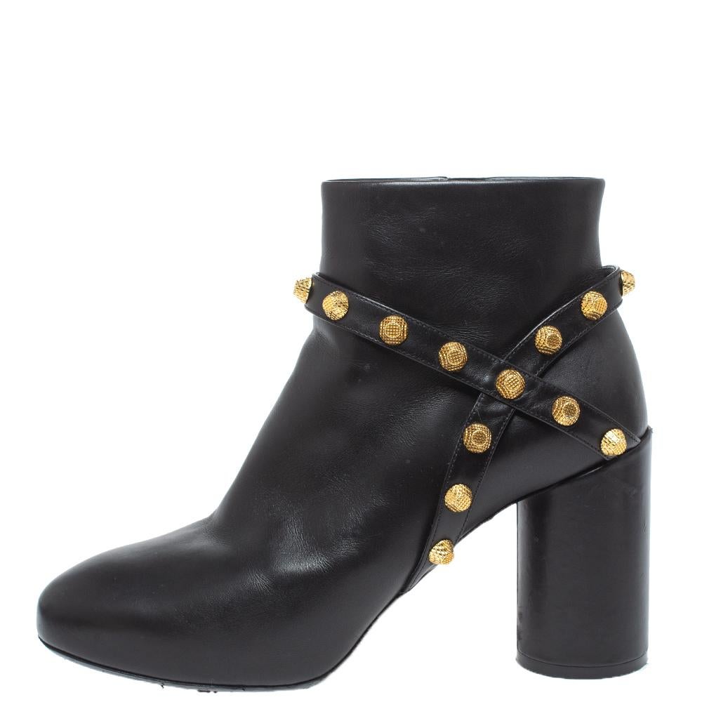 Exclusively crafted by the best, for the best, these boots are from the house of Balenciaga. The luxurious leather material makes these boots comfortable wear. They feature round toes, stud-embellished straps, and 9 cm block heels.

