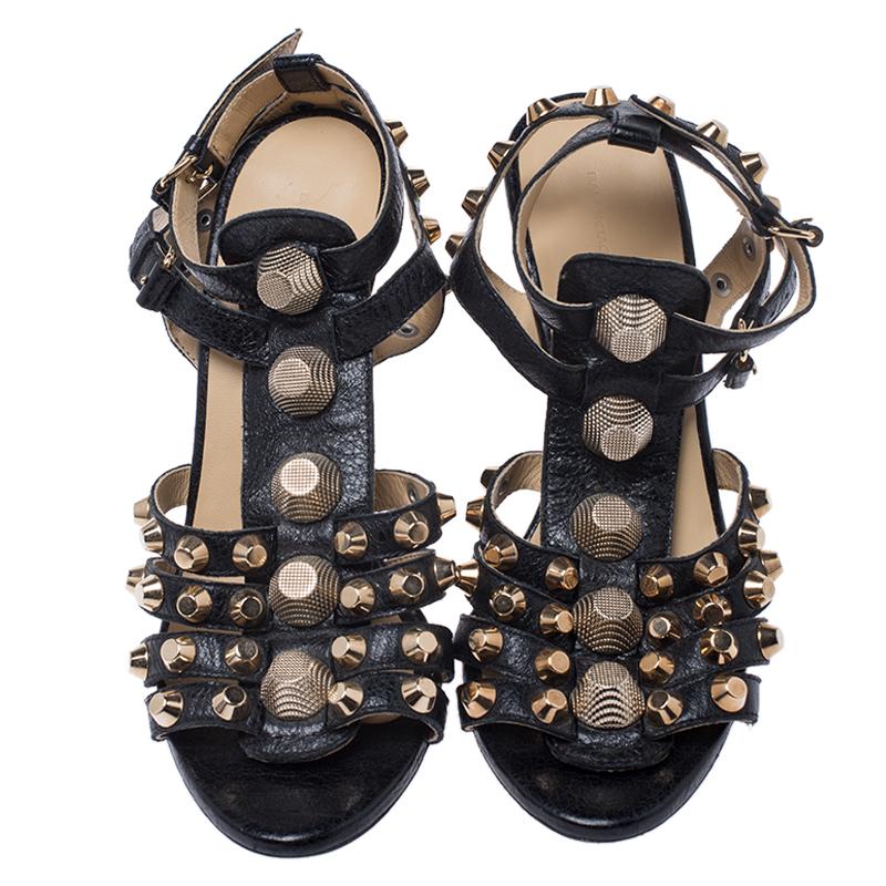 These stunning sandals by Balenciaga will make a statement. Crafted from leather, they come in black. These gladiator style wedge heels feature straps embellished with gold-tone studs, buckle closure, 11 cm heels, and leather soles. They are