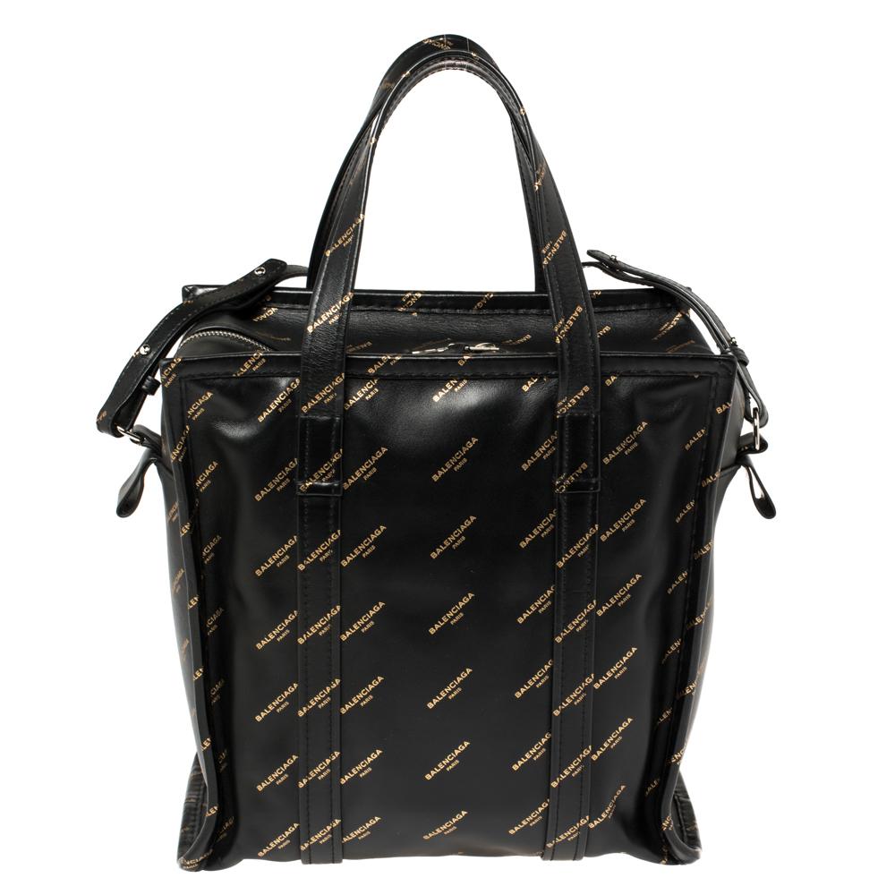 Designed to make your shopping sprees stylish and comfortable, Balenciaga's Bazar tote is a must-have. While the signature print elevates the black leather exterior, the roomy fabric interior makes it truly functional. Two top handles and a shoulder